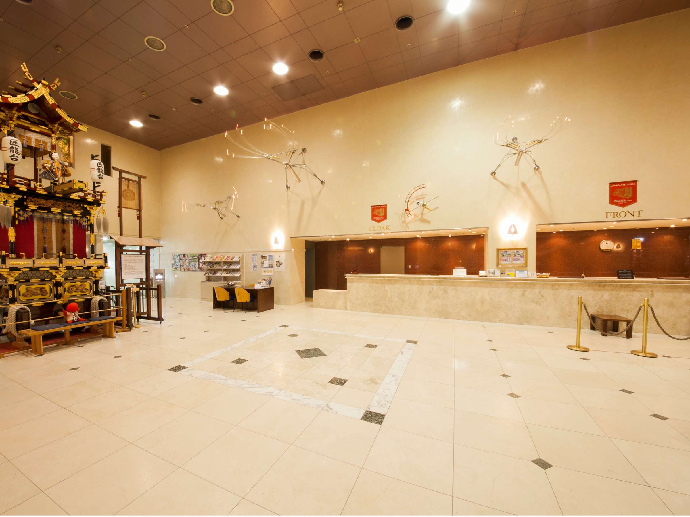 Spacious lobby of Hida Hotel Plaza in Takayama displaying an ornate festival float and reception desk