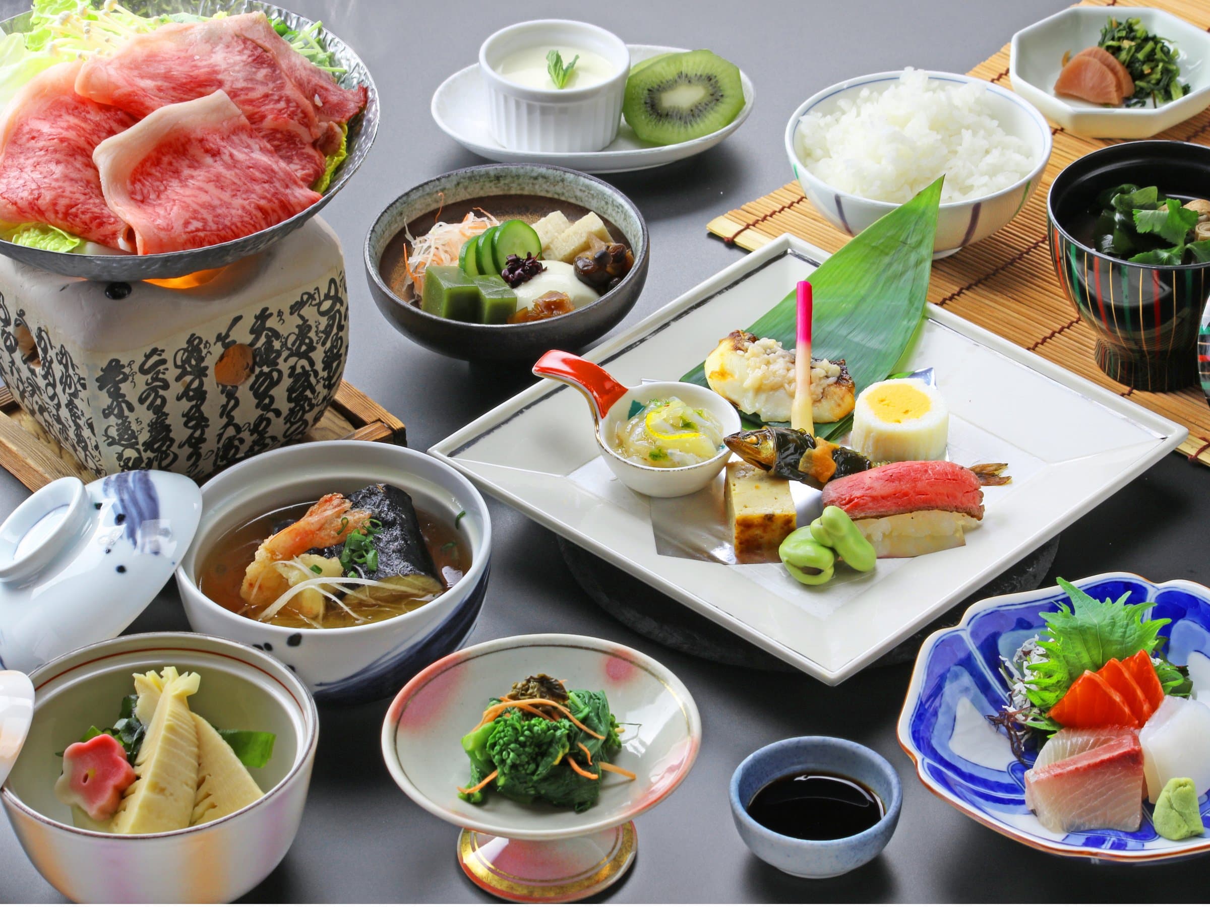 Hida beef kaiseki dinner spread at Hida Hotel Plaza with sashimi, simmered dishes and rice