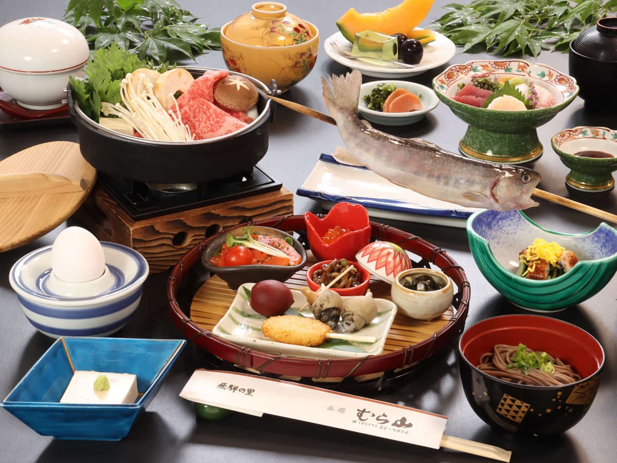 Hida kaiseki dinner spread at Ryokan Murayama with beef hotpot, grilled river fish and small dishes