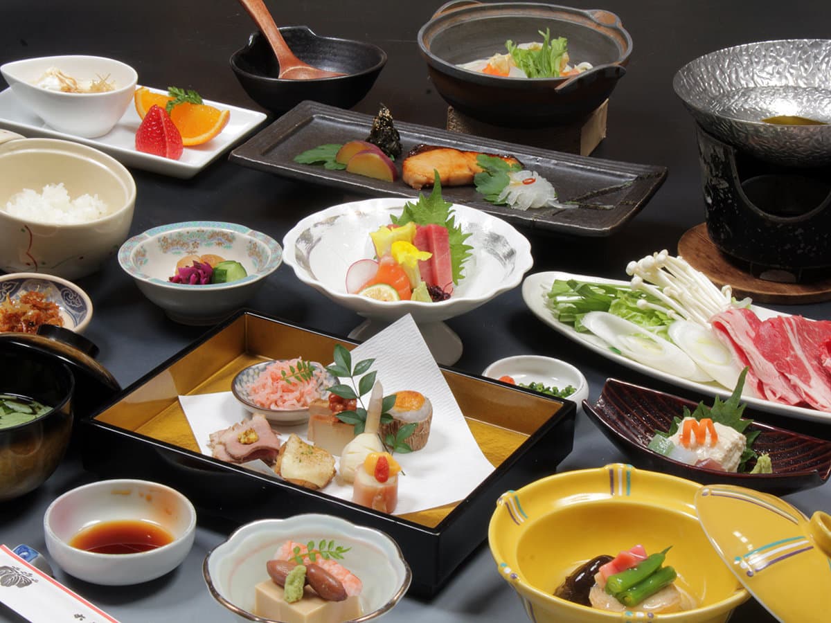Multi-course Japanese kaiseki dinner with simmered hot pot, sashimi, grilled fish and seasonal small dishes