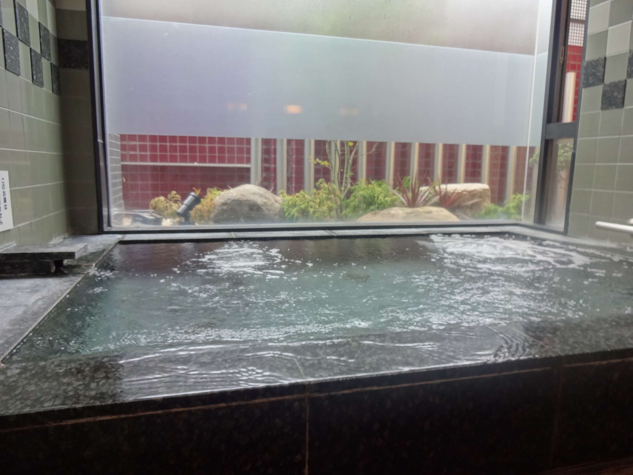 Suizanso Kinosaki Onsen indoor hot spring bath with large window and natural light