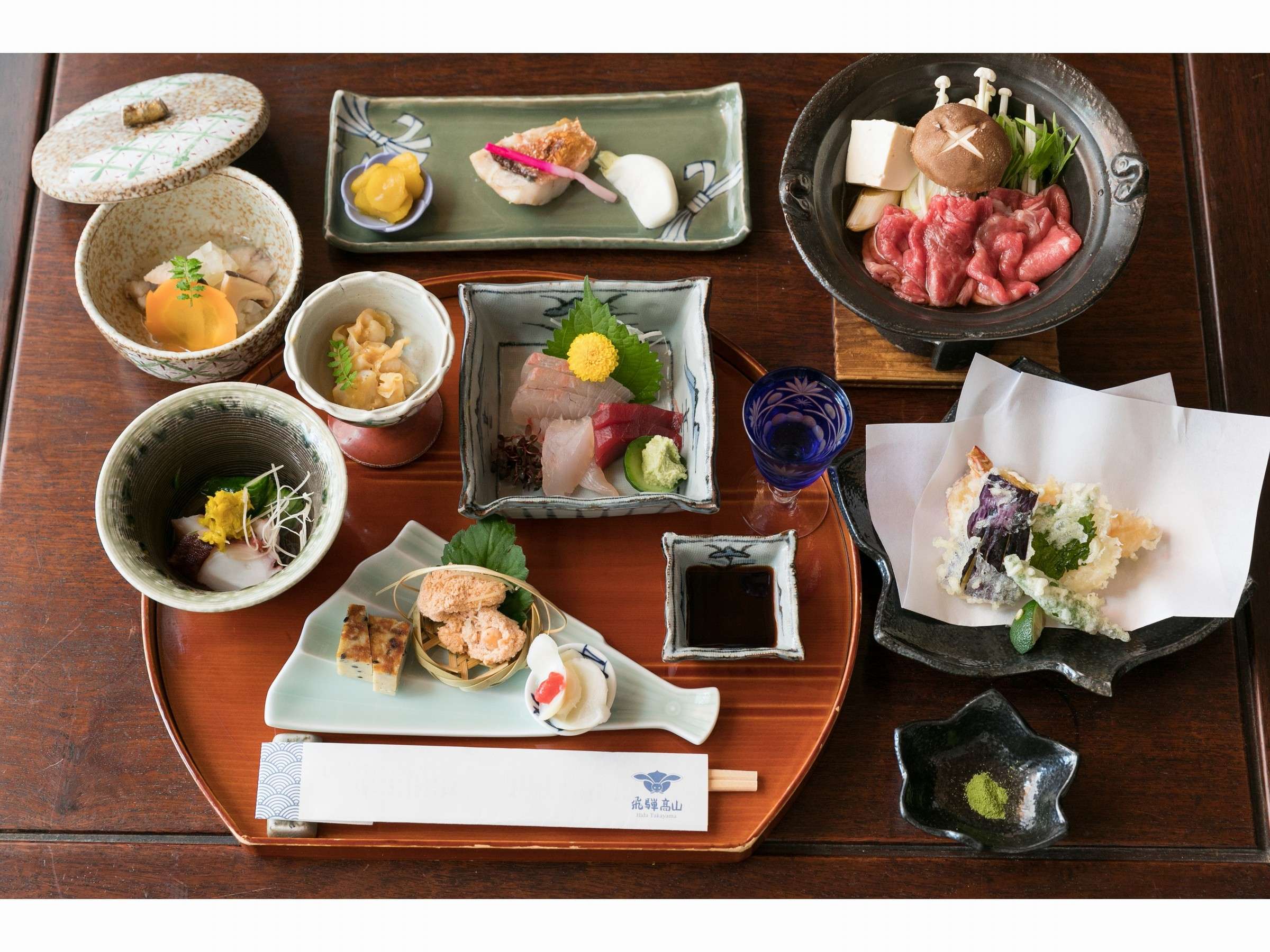 Hida beef kaiseki dinner tray at Sumiyoshi Ryokan with sukiyaki hot pot, sashimi, tempura and simmered dishes, Takayama