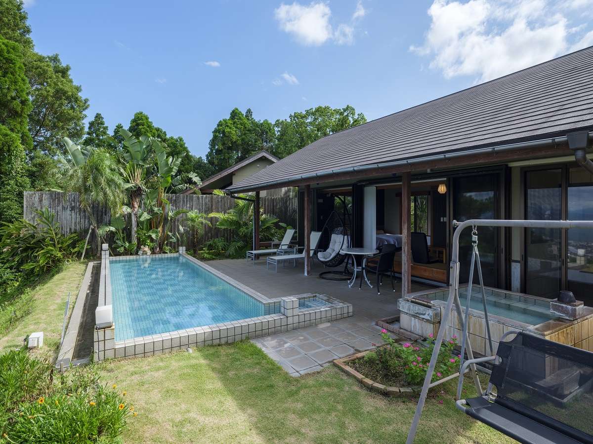 Yurian guest villa with its own tiled hot-spring pool, lounge chairs and private outdoor bath in a garden at Ibusuki Onsen