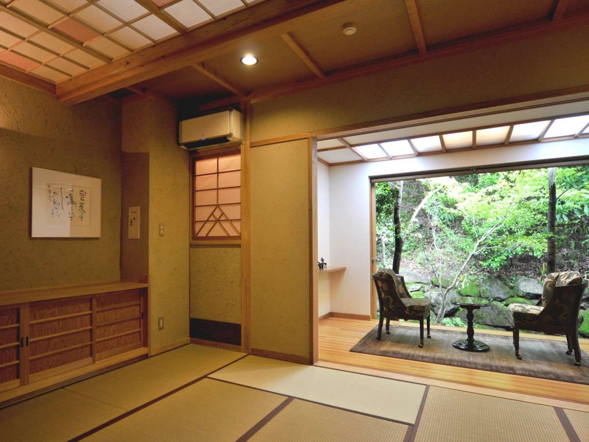 Tatami common lounge at Oyado Nonohana opening through shoji onto a green garden