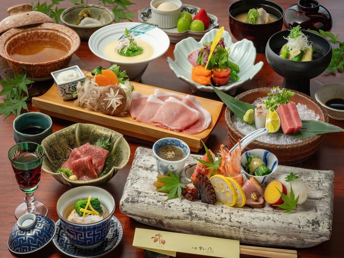 Multi-course kaiseki dinner spread at Oyado Nonohana with sashimi, wagyu and seasonal small dishes