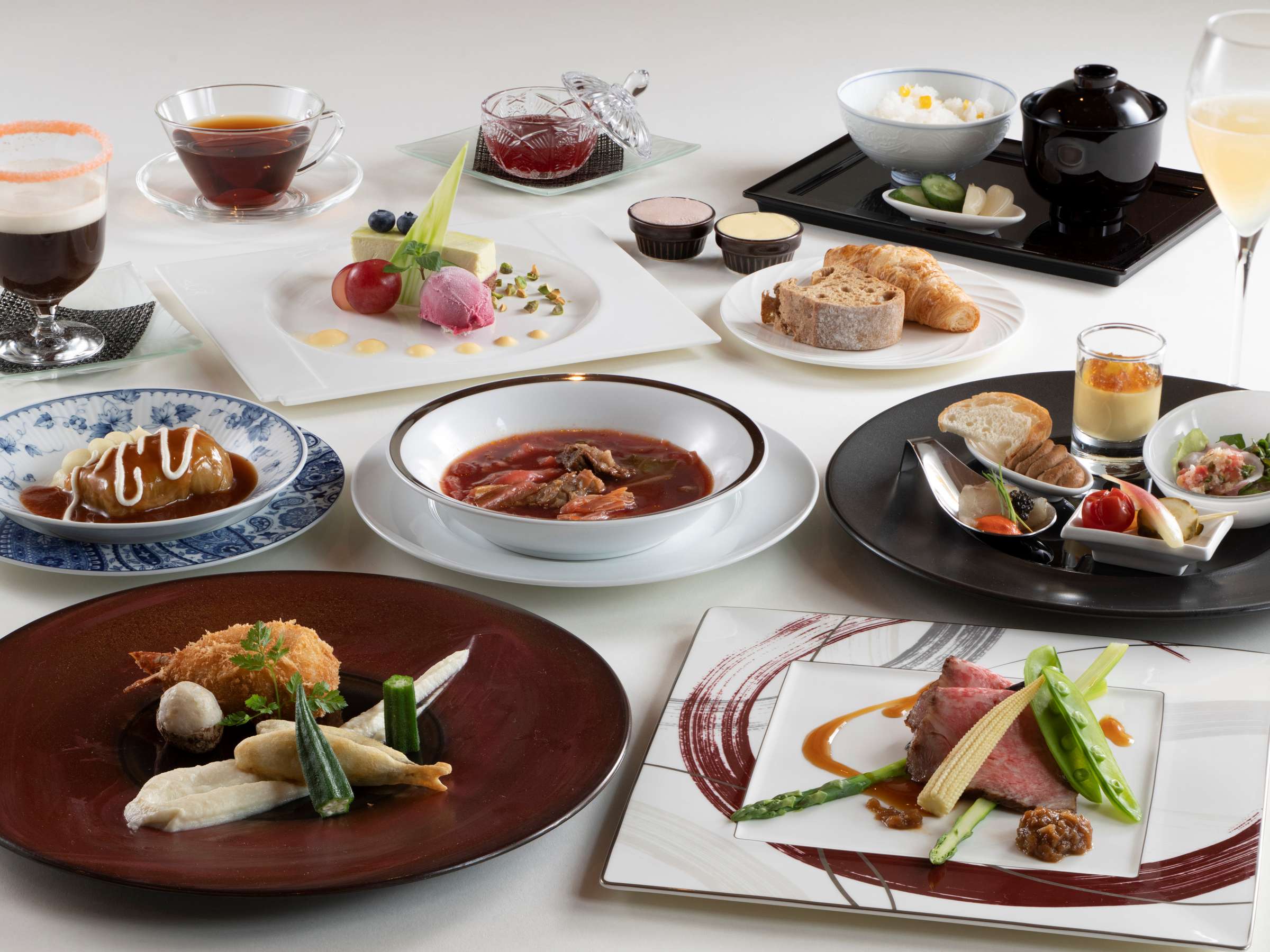Multi-course dinner at La Vista Kusatsu Hills with roast beef, borscht, fried prawn, dessert and rice set plated across the table