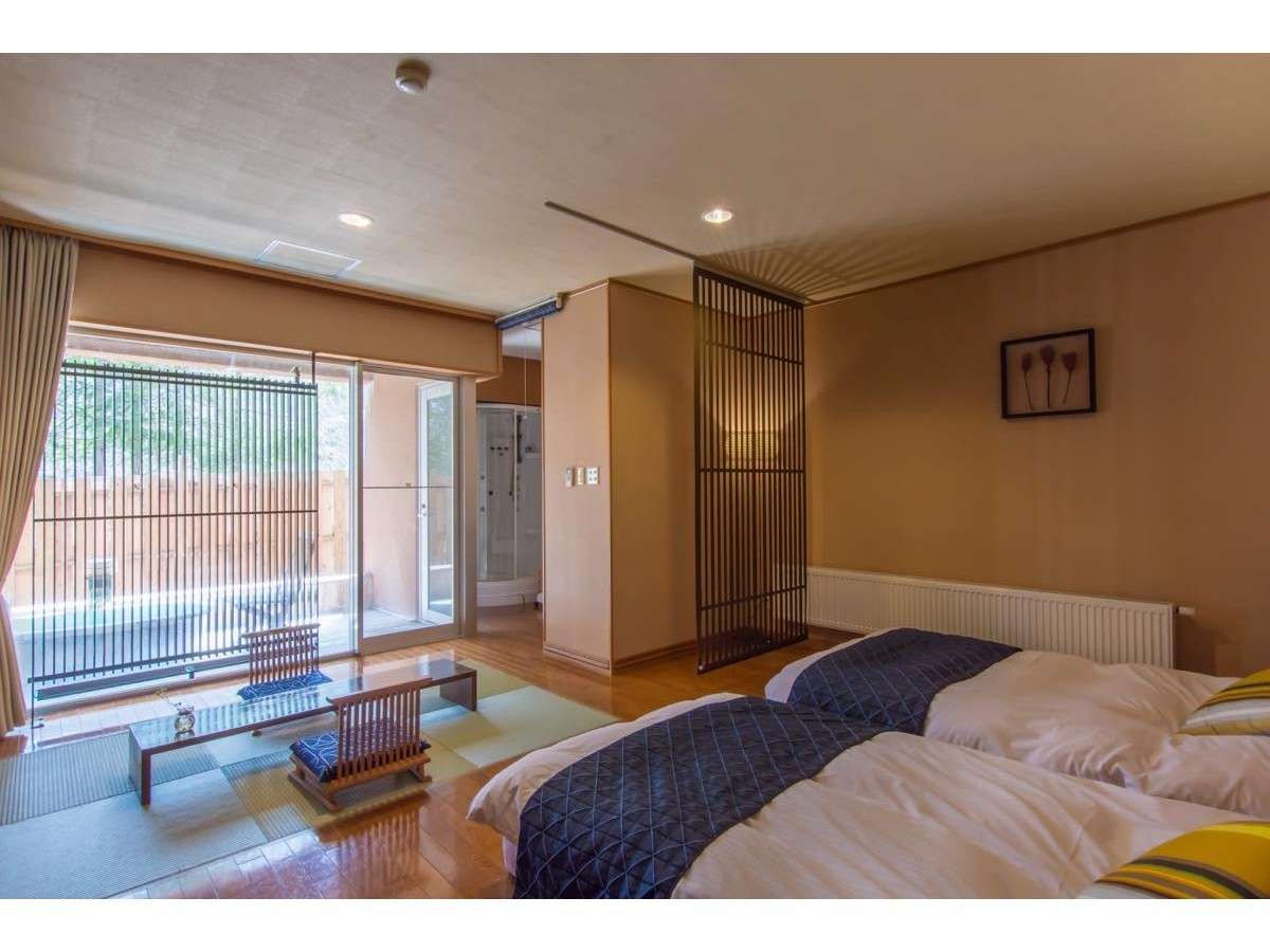 Japanese-Western twin guest room with tatami corner and a private bath beside the window at Okunikko Yuno-mori