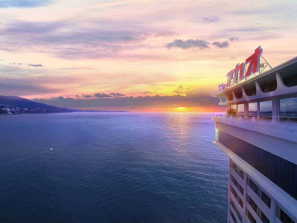 Hotel New Akao Ocean Wing clifftop exterior above Sagami Bay at sunset, Atami Onsen