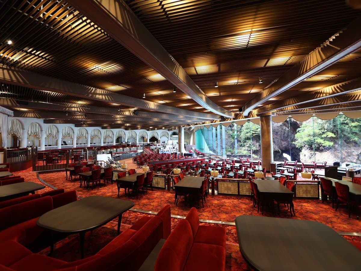 Main Dining Nishiki restaurant interior with timber ceiling and red seating at Hotel New Akao, Atami