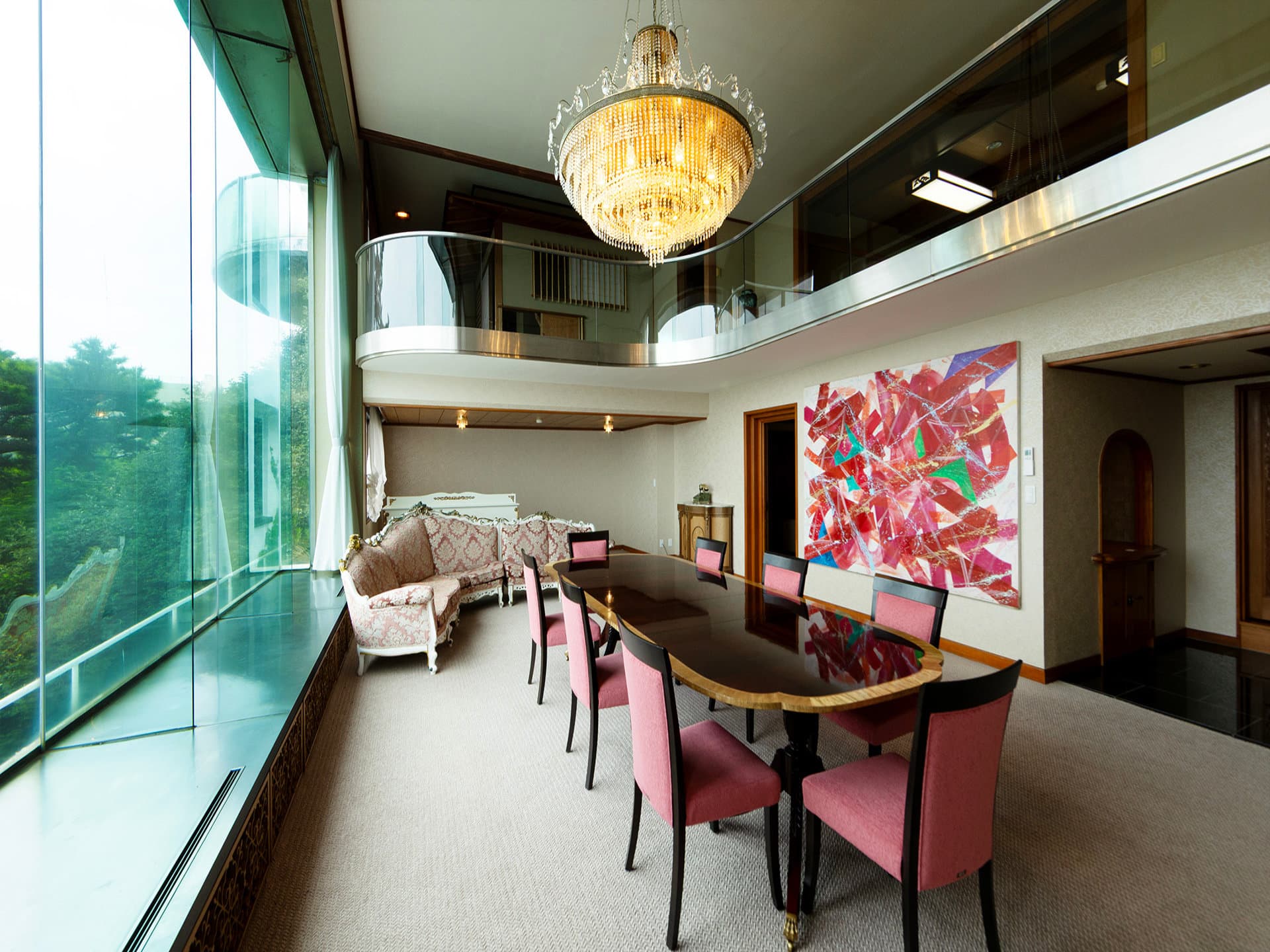 Imperial Suite living room with chandelier and sea-facing glass wall at Hotel New Akao, Atami