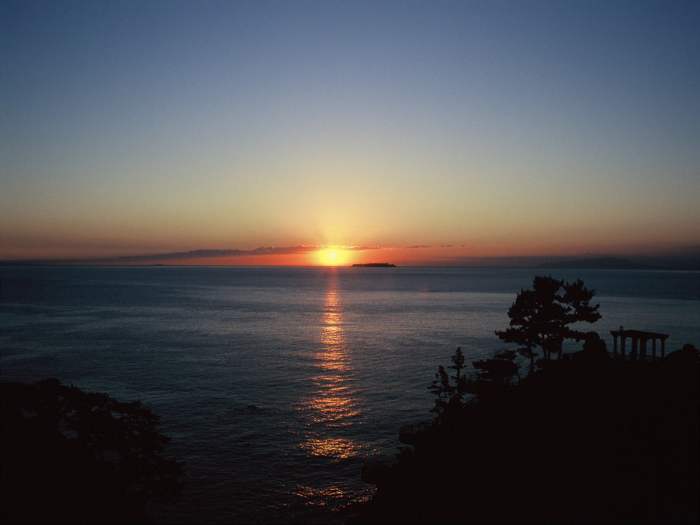 Sunrise over the sea seen from the clifftop grounds of Hotel New Akao, Atami Onsen