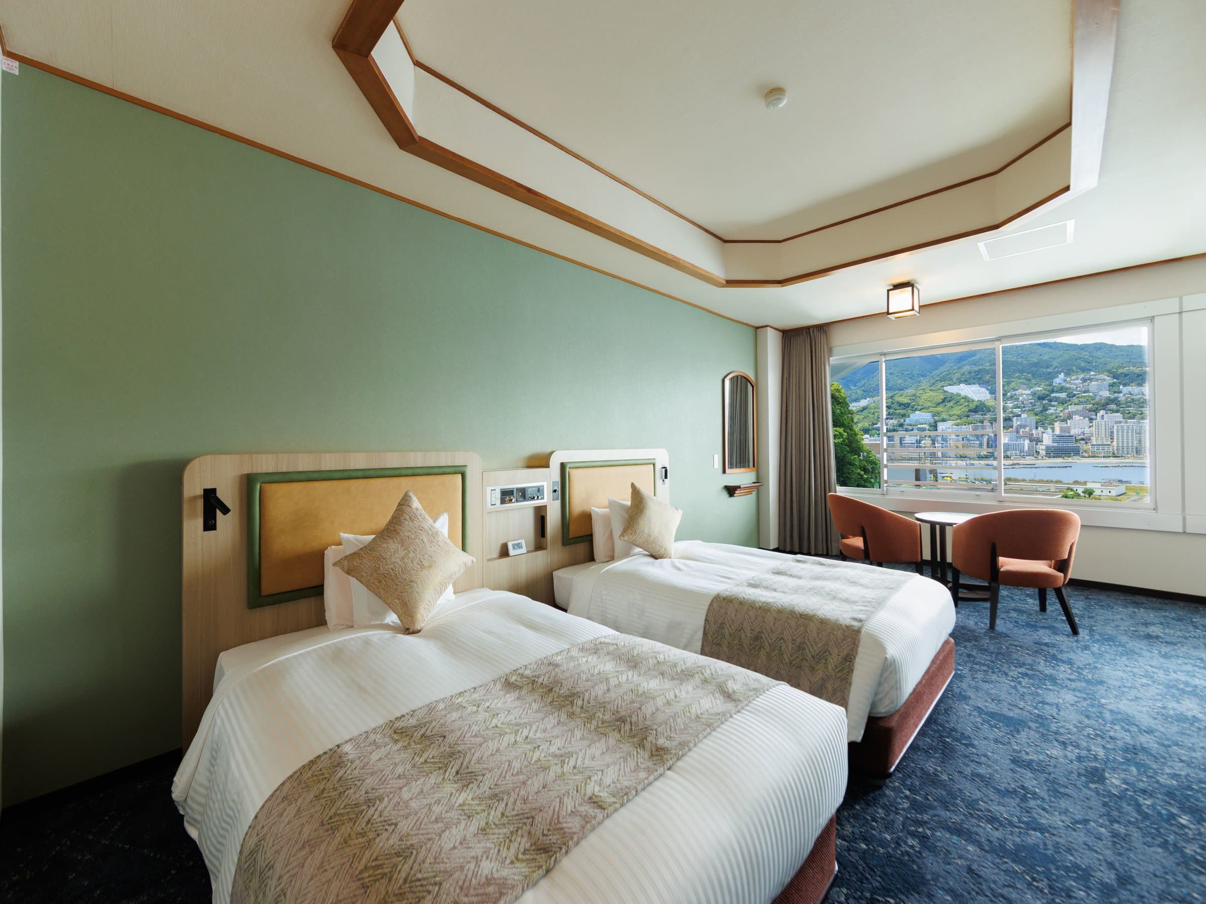 Premier Japanese-Western twin room with green accent wall and Atami town view at Hotel New Akao