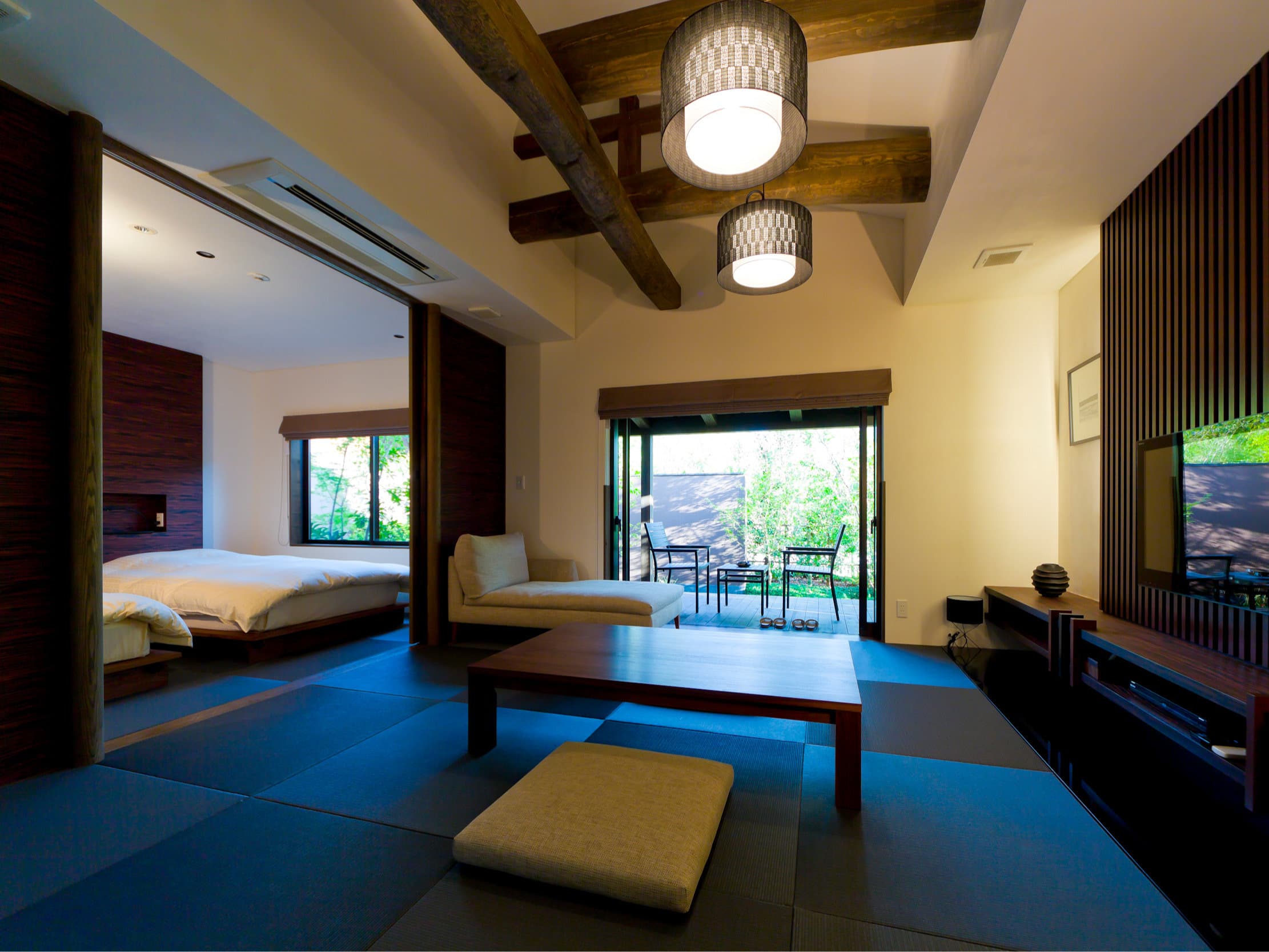 Premium guest room combining tatami floor, a low bed and a private garden terrace at Yufuin Bettei Itsuki