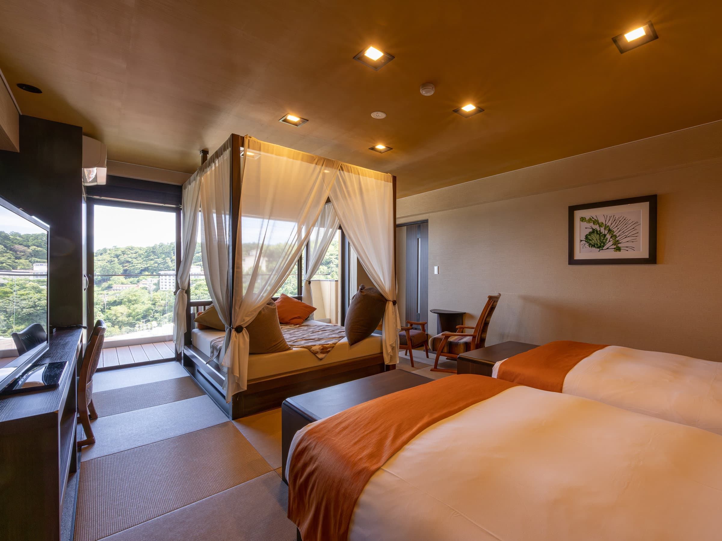 Premium guest room with twin beds and a curtained canopy day-bed beside an ocean-view balcony at Atagawa Prince Hotel