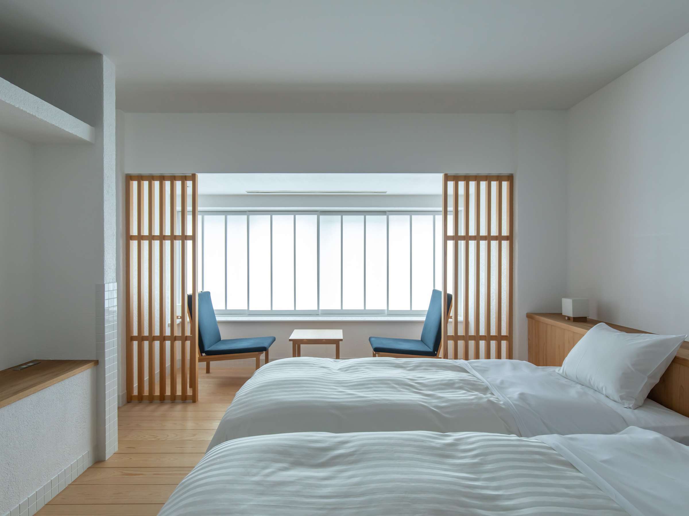 Twin-bed guest room with wooden lattice screens and a window seating nook, Sensui, Kinosaki Onsen