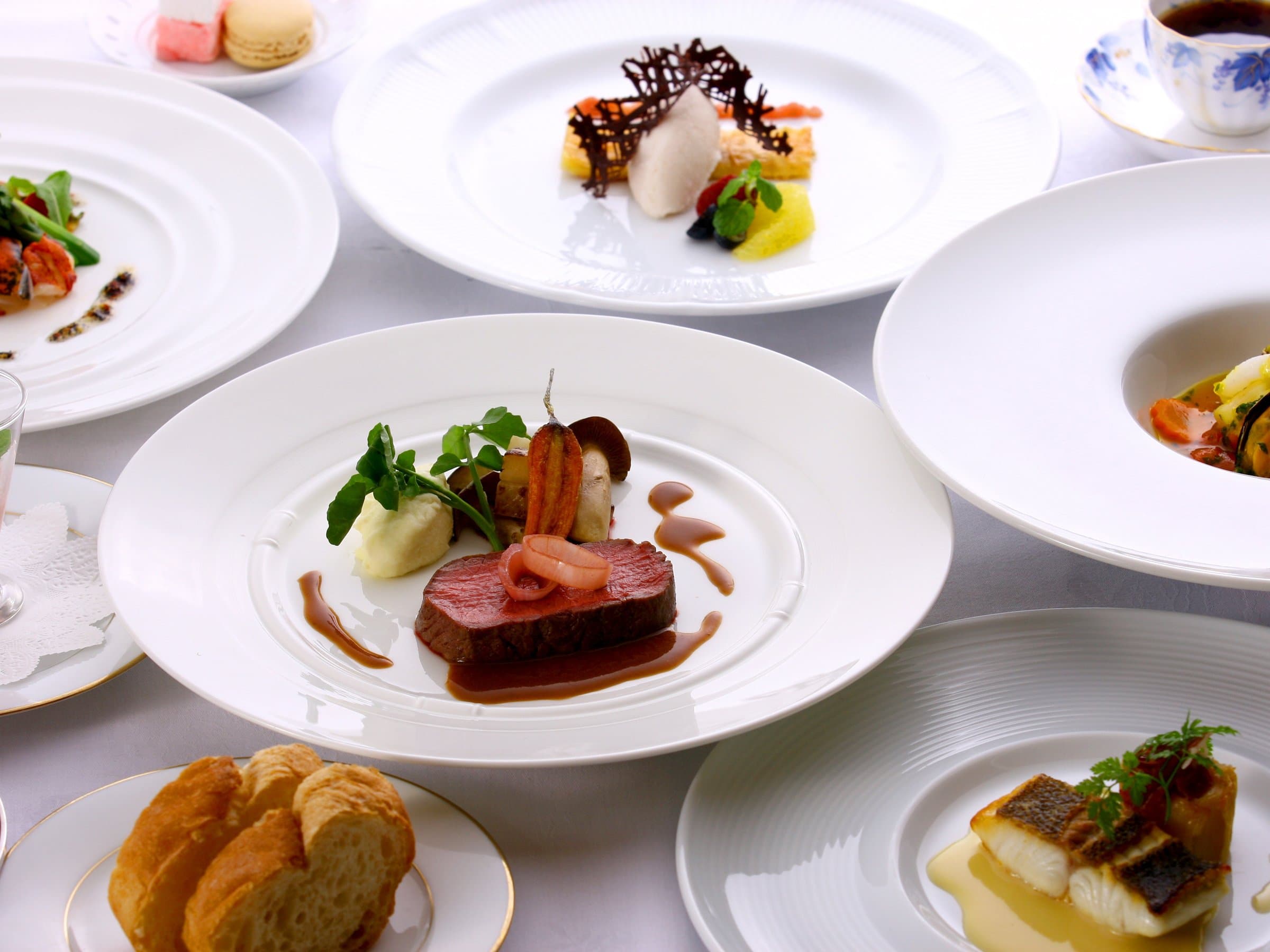 French-style multi-course dinner with plated beef, fish and dessert
