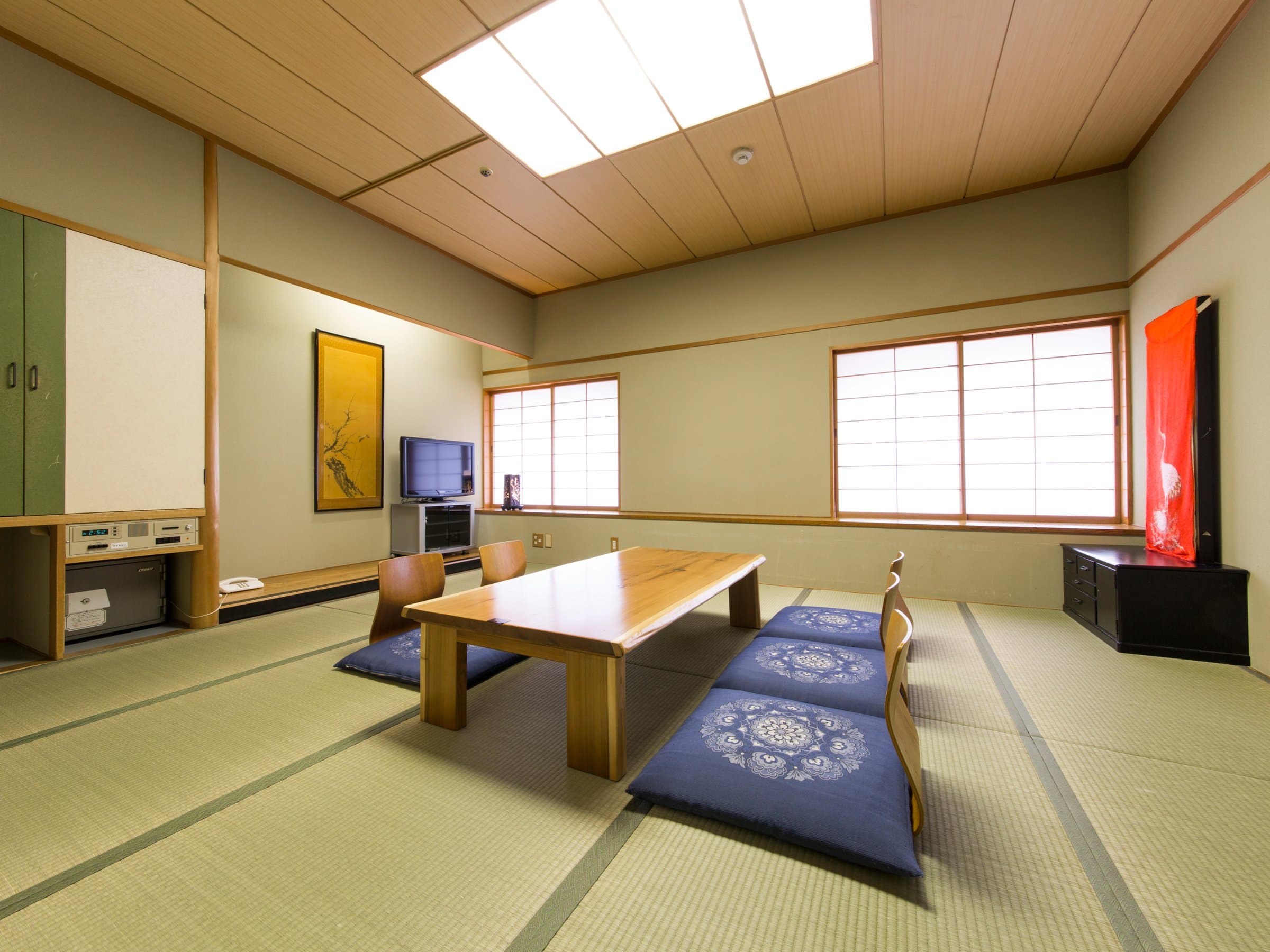 Spacious Japanese-style tatami guest room with low table and tokonoma alcove