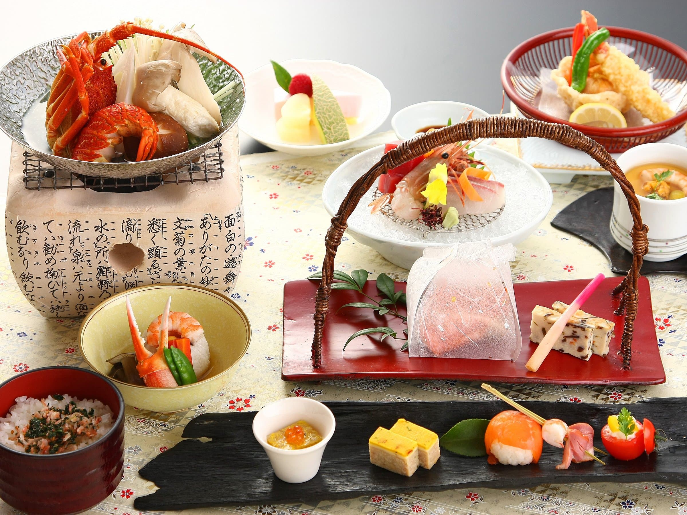 Japanese kaiseki dinner spread with sashimi, tempura and seasonal small dishes