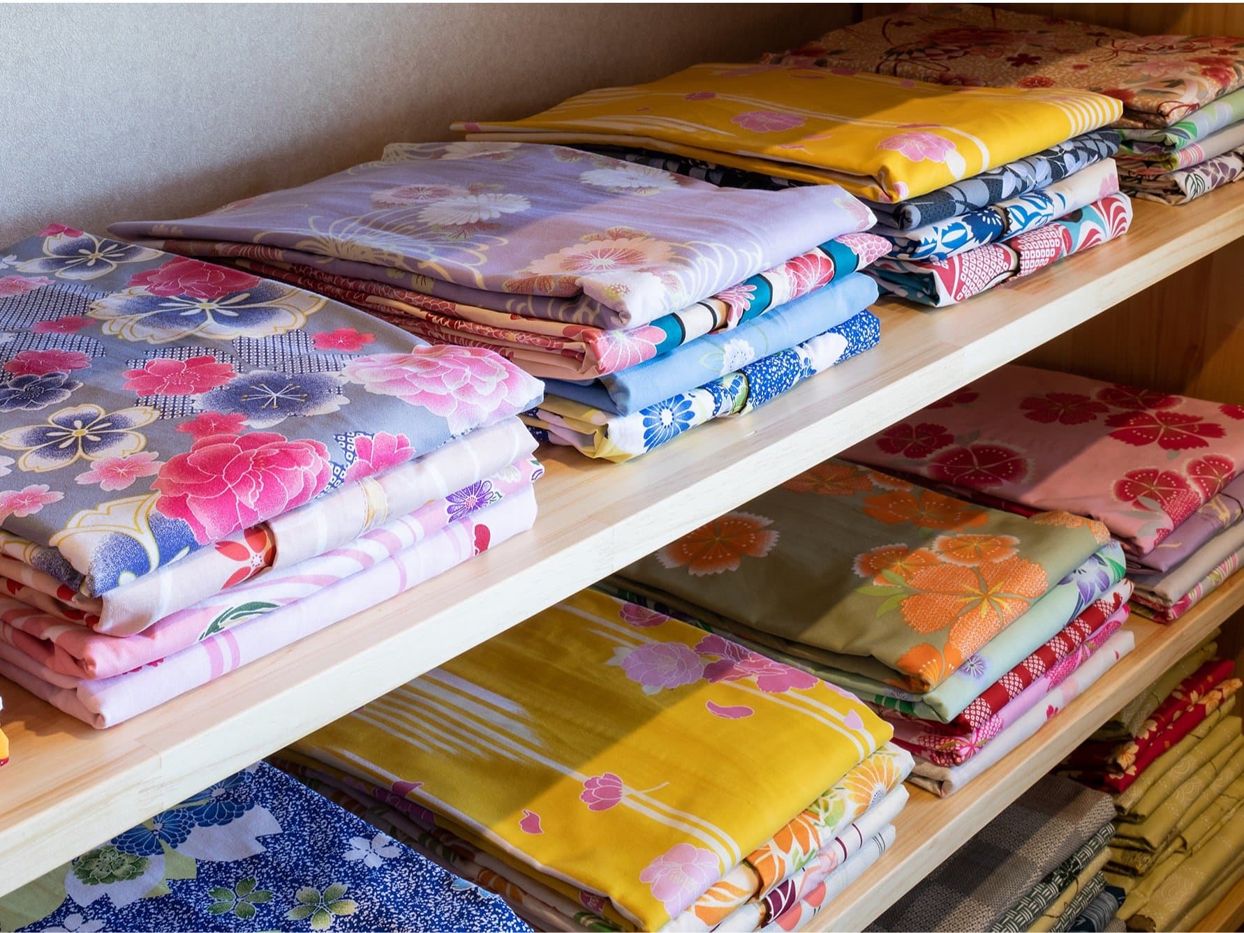 Shelves of colorful patterned yukata available to guests at Suehiroya Ryokan