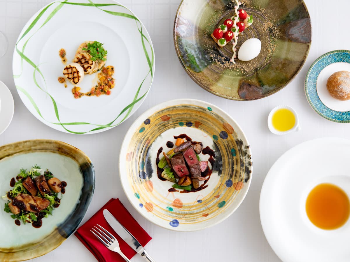 Multi-course French dinner of plated dishes on artisan ceramic plates at Hotel Sierra Resort Hakuba