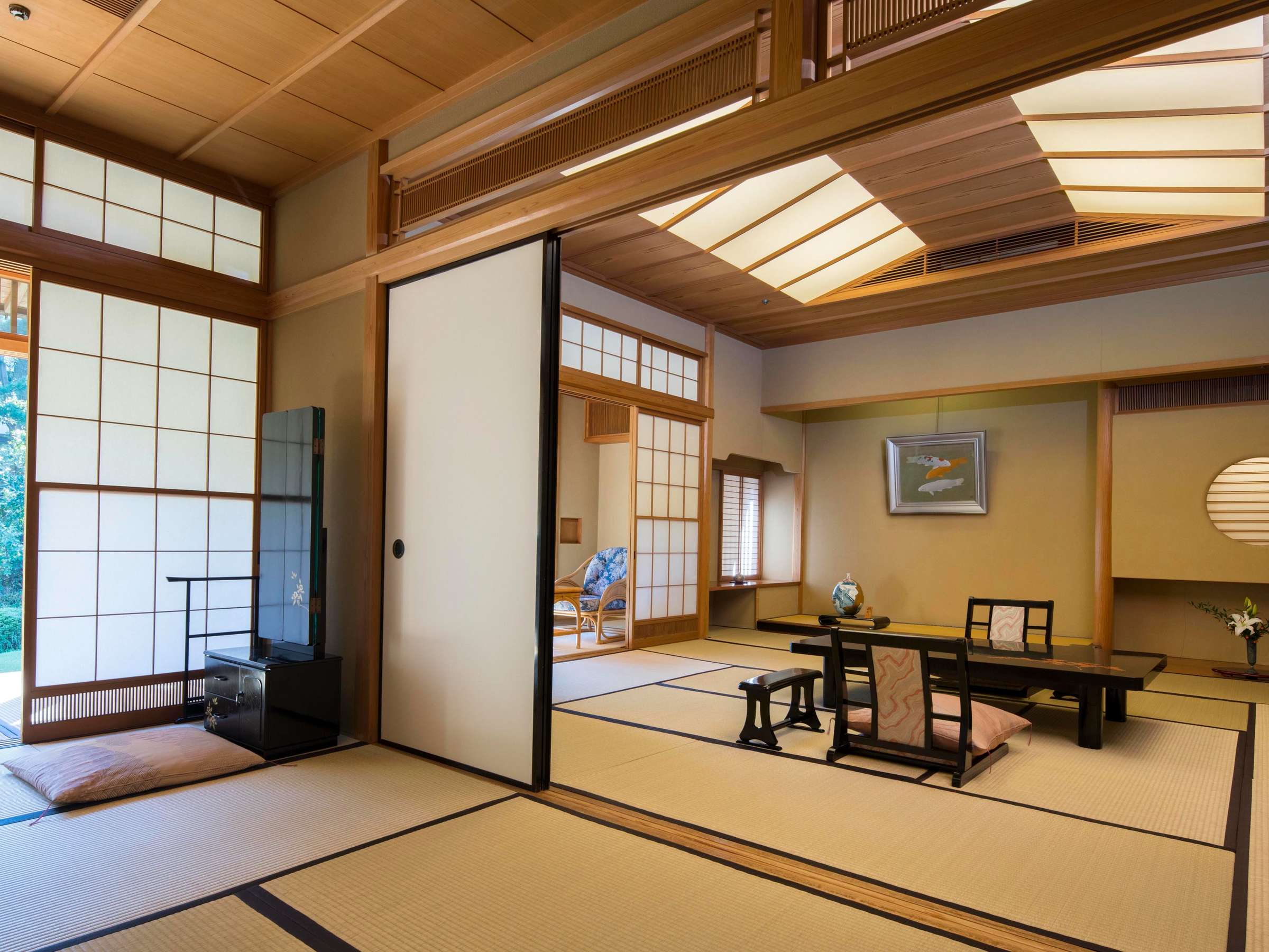 Spacious traditional tatami guest room with shoji screens, low table and tokonoma alcove at Atami Koarashitei