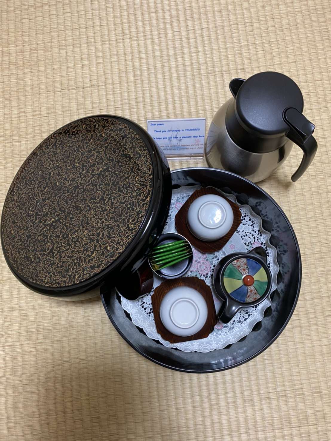 In-room Japanese green tea set with cups and a thermal pot arranged on tatami at Toukaisou
