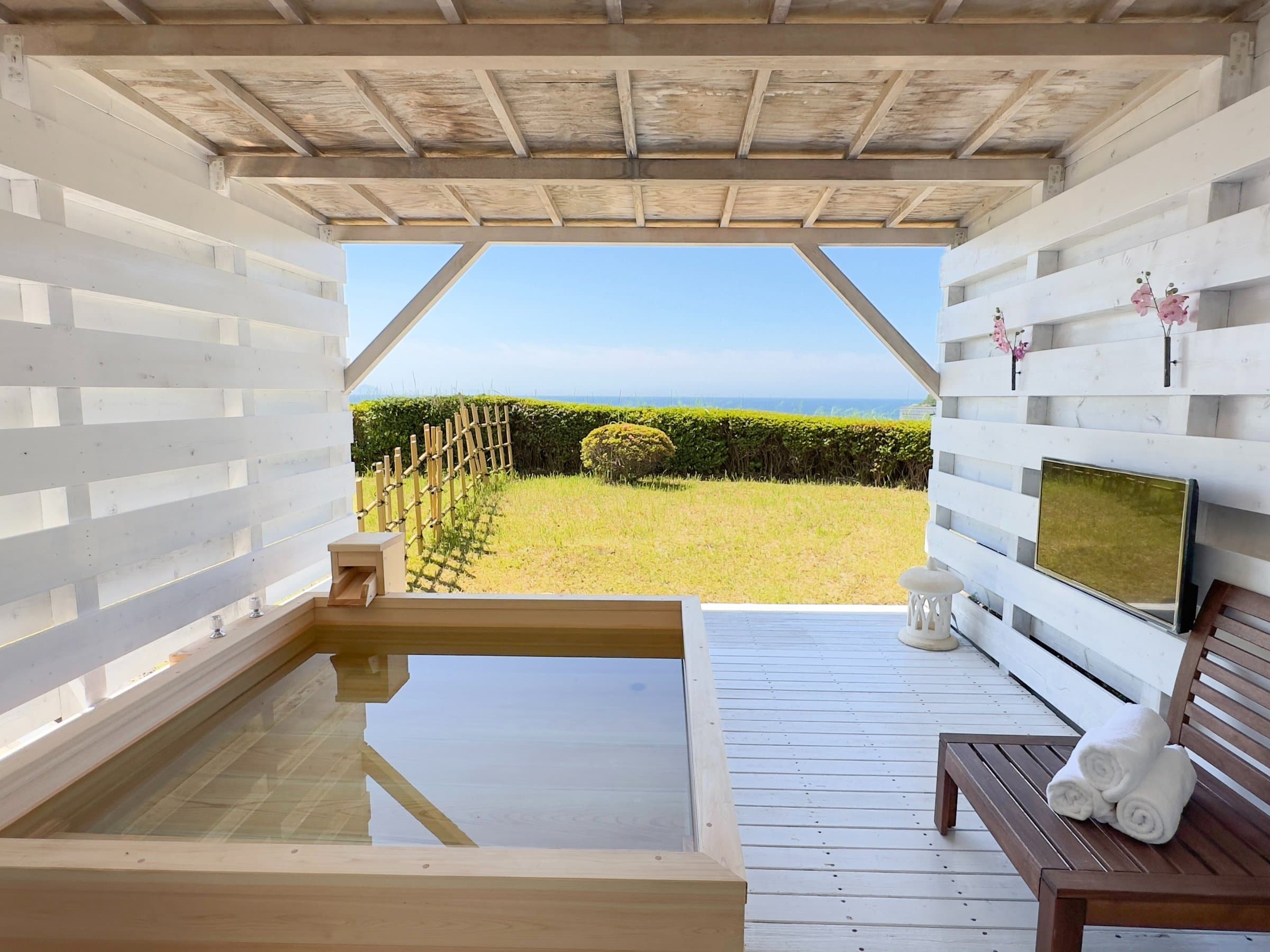 Private hinoki cypress open-air bath on a deck with lawn and ocean view in a guest room, Hotel Katara Izu