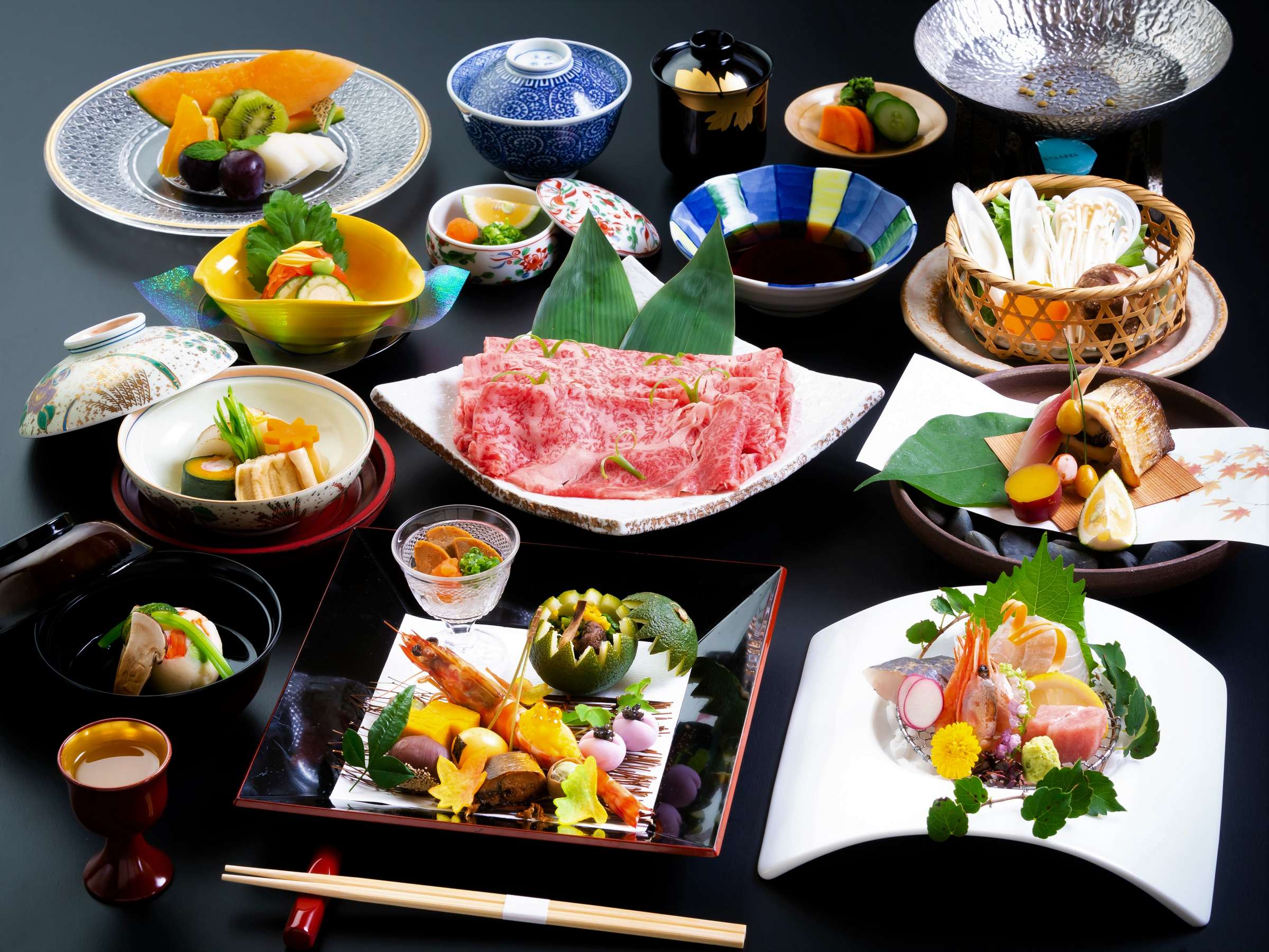 Elaborate multi-course kaiseki dinner spread with marbled wagyu, sashimi and seasonal small dishes, Kappo Ryokan Kannawa Bettei, Beppu Onsen
