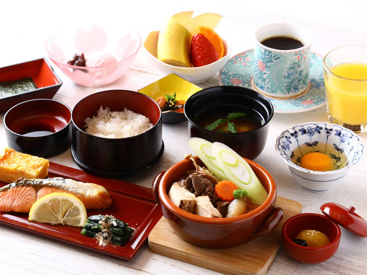 Japanese breakfast set at Ryokan Kamogawa Asakusa with grilled salmon, rice, miso soup, beef hotpot and fresh fruit