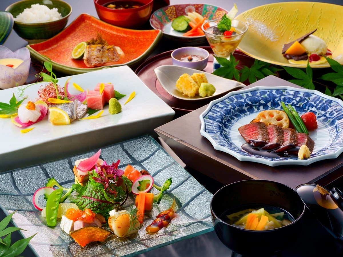 Kaiseki dinner spread at Tosyoan with sashimi, grilled wagyu and seasonal small dishes on colorful tableware
