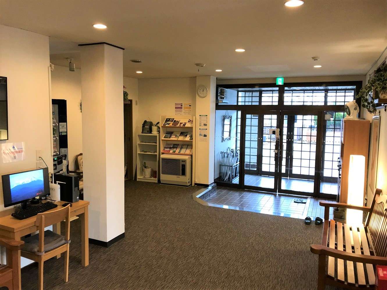 Entrance lobby and genkan of K's House Fuji View with shoji-style front doors