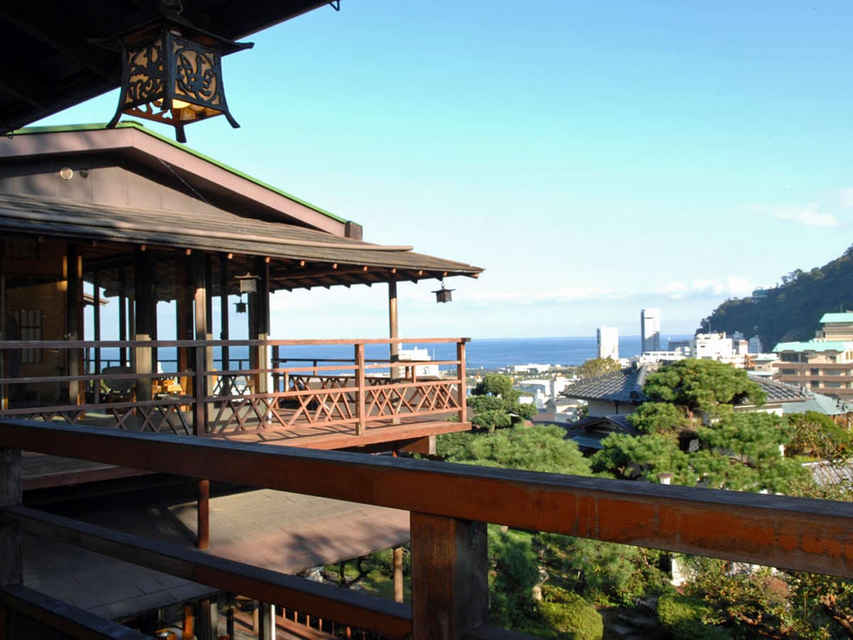 Wooden veranda and traditional architecture of Shin Kadoya in Atami with an ornate lantern and sea view