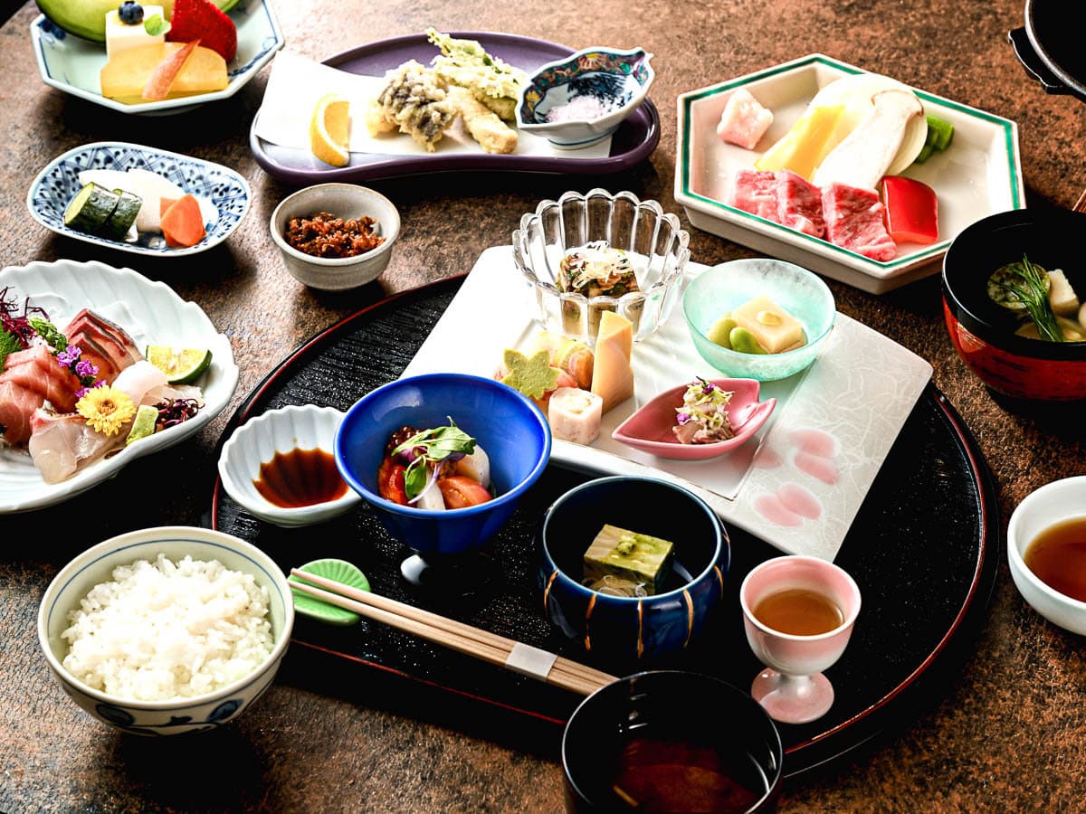 Multi-course kaiseki tray at Shin Kadoya featuring sashimi, tempura, rice and seasonal appetizers