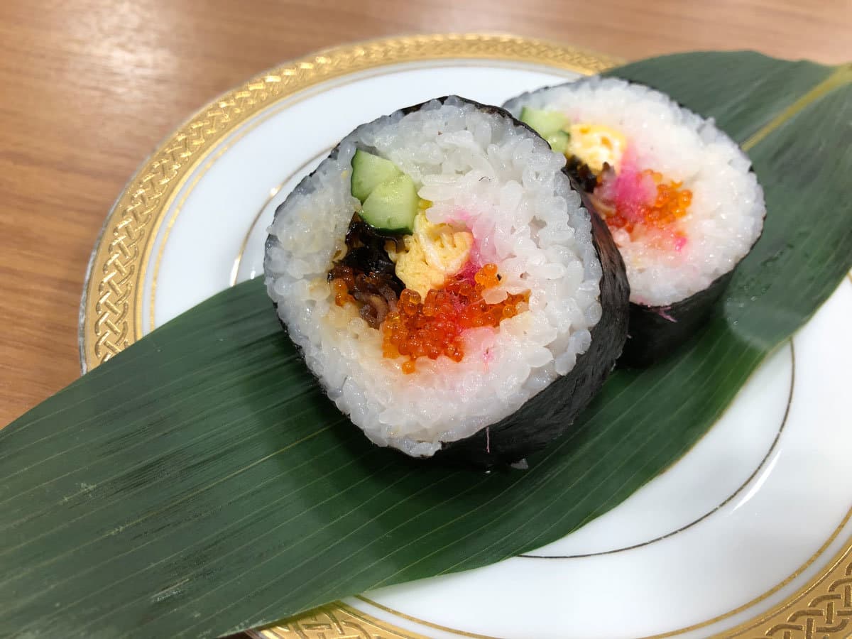 Plated futomaki sushi rolls on a bamboo leaf, part of a meal at Hotel Harumoto in Nikko