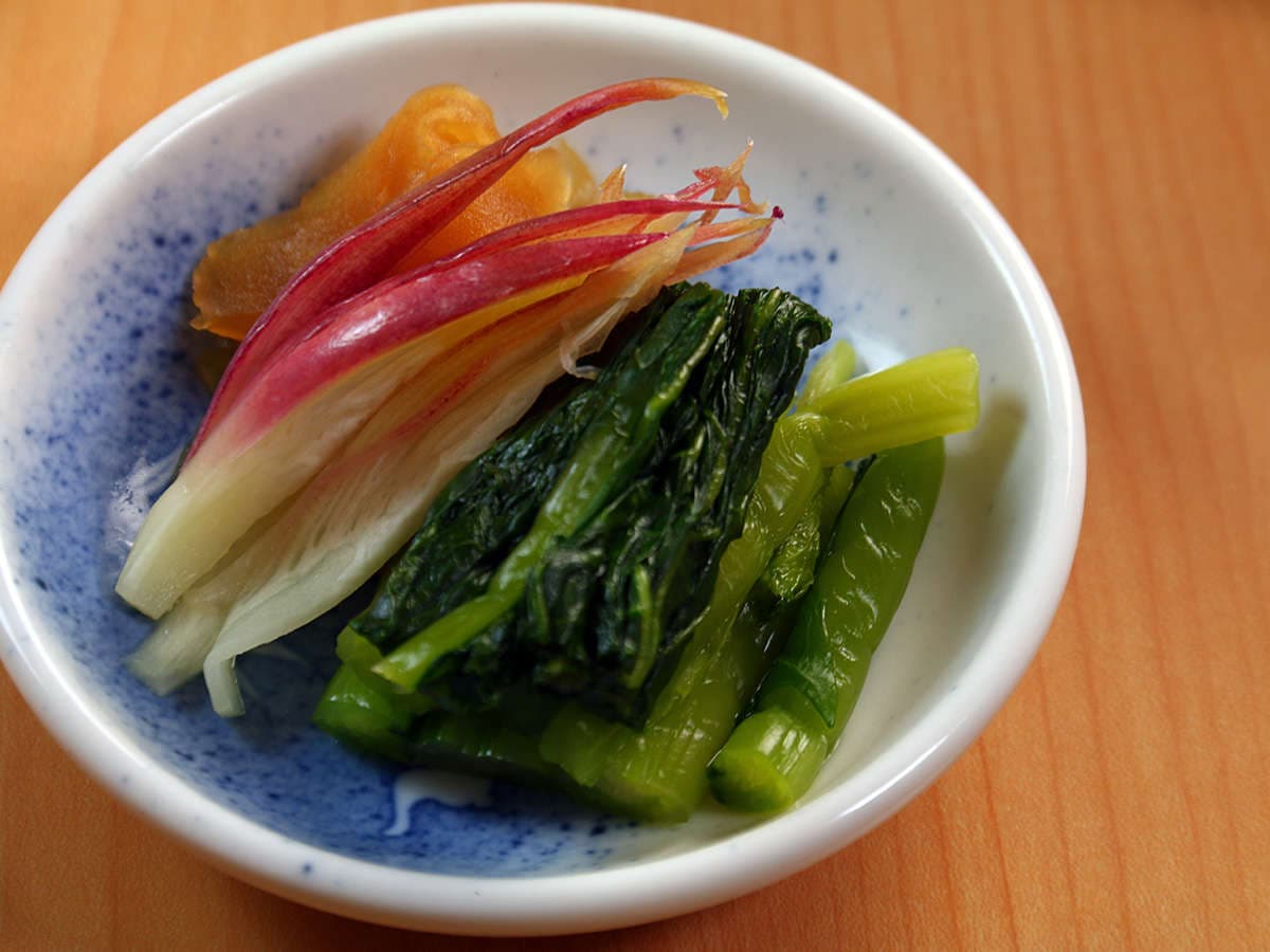 Small dish of brightly colored pickled vegetables served with a meal at Oomukou Ryokan in Hakuba