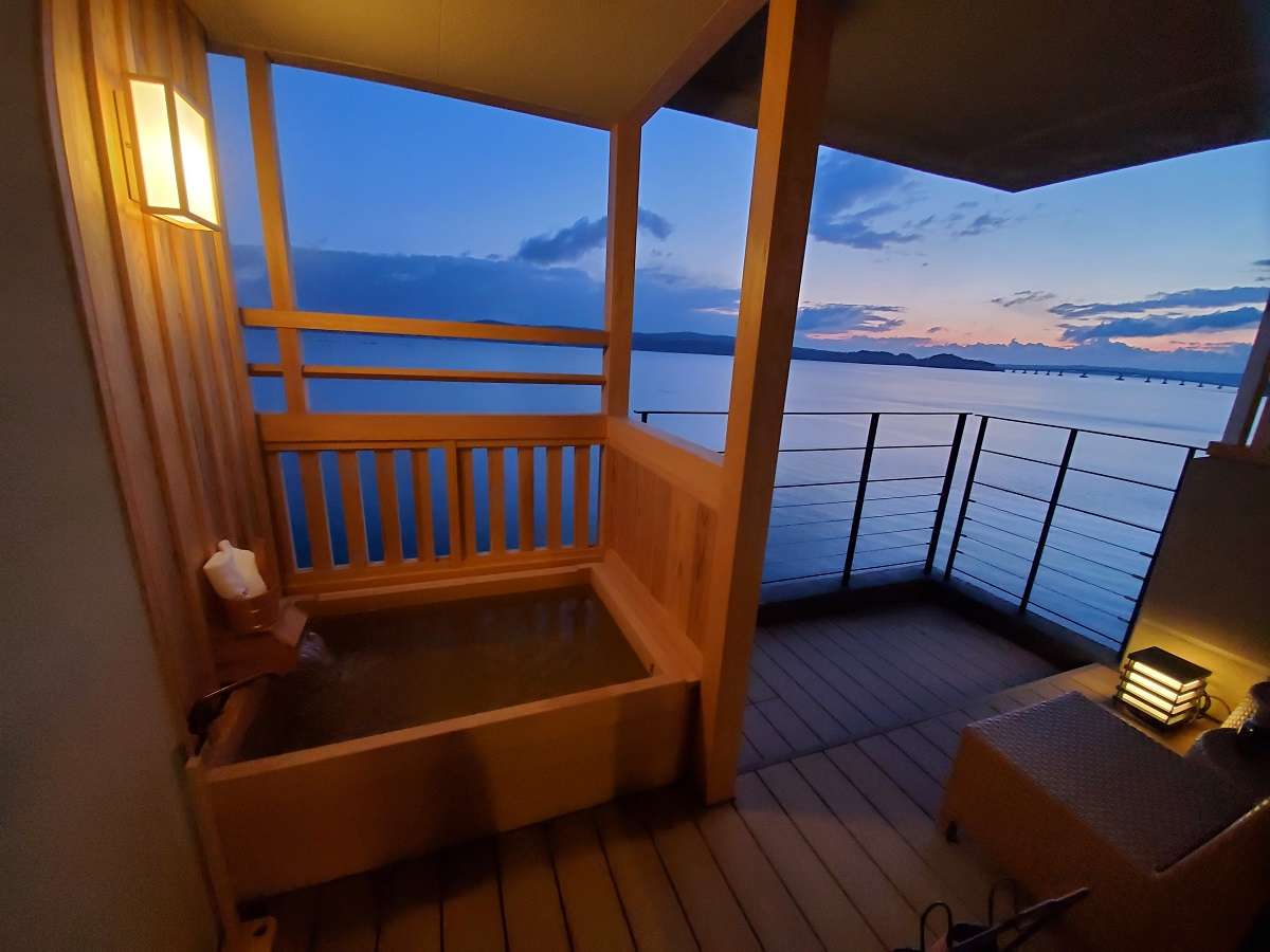 Private in-room open-air cypress bath overlooking Nanao Bay at dusk at Noto Kaishu in Wakura Onsen