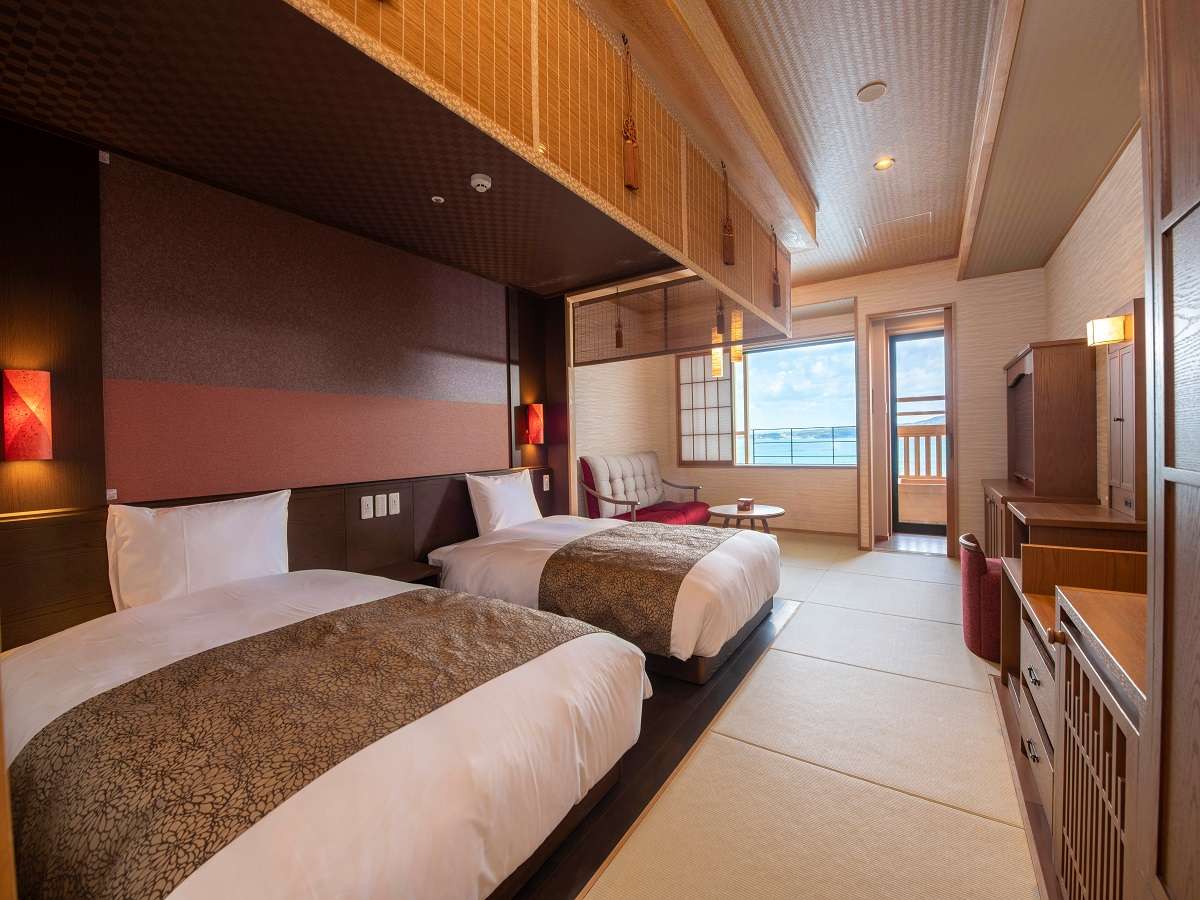 Modern Japanese-Western twin room with sea-view balcony seating at Noto Kaishu in Wakura Onsen