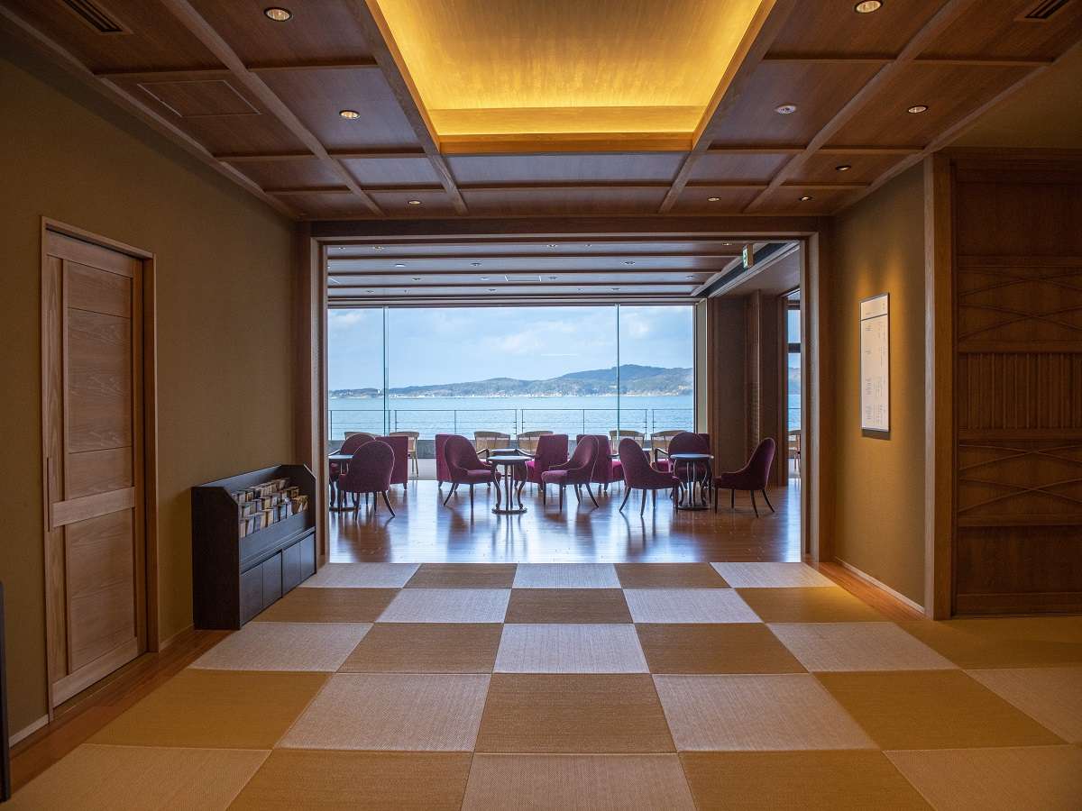 Lobby lounge with bay-view seating and floor-to-ceiling glass at Noto Kaishu in Wakura Onsen