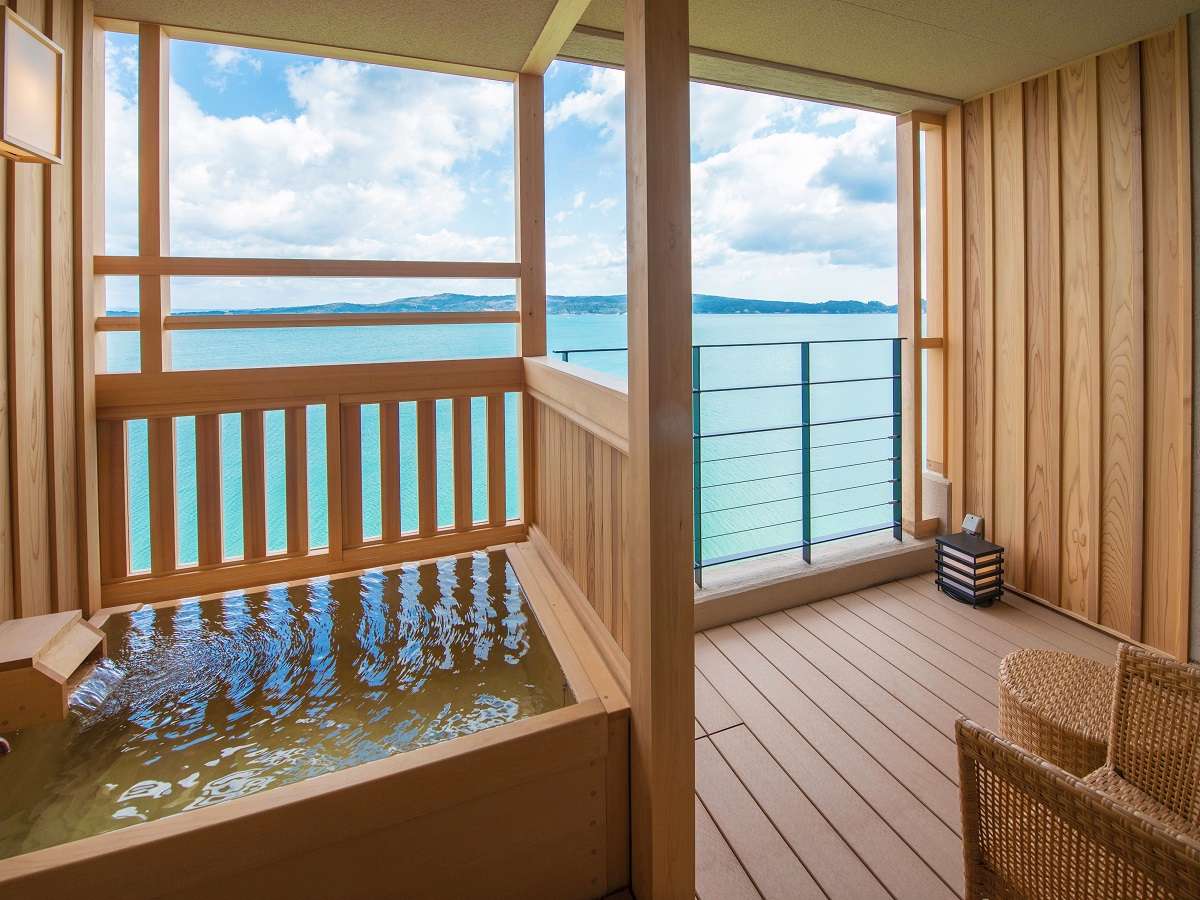 Private guest-room open-air hinoki tub with turquoise bay view by day at Noto Kaishu, Wakura Onsen