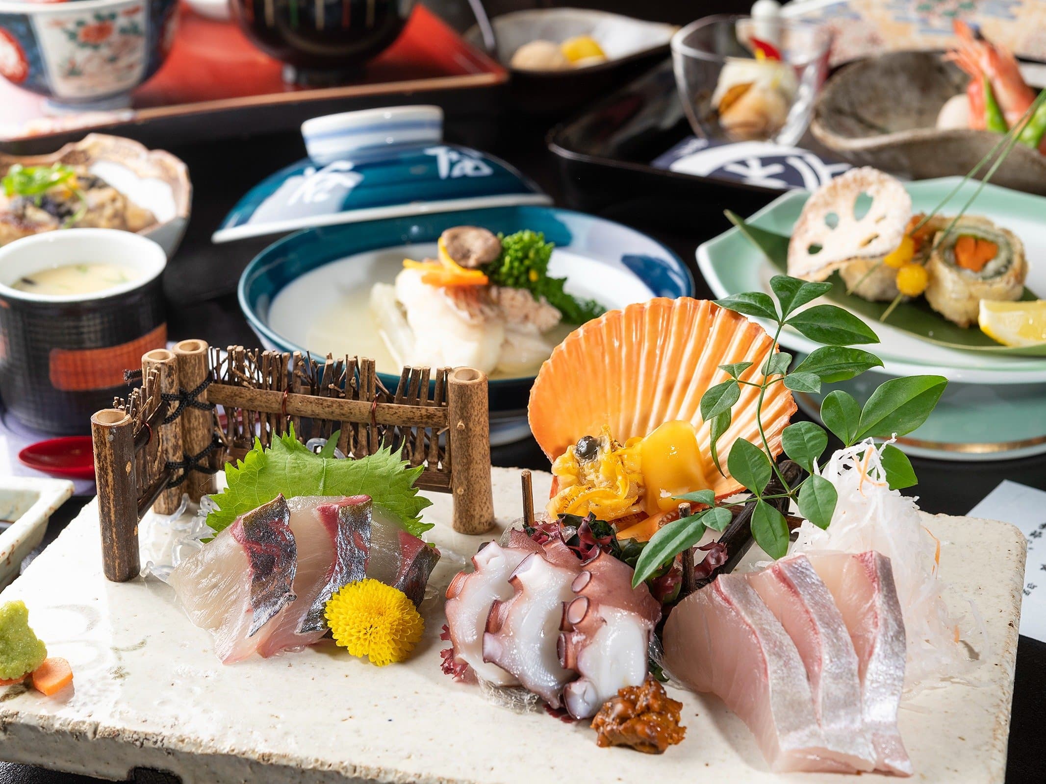 Kaiseki dinner spread at Yado Taniya featuring sashimi, scallop and assorted small dishes from the Seto Inland Sea