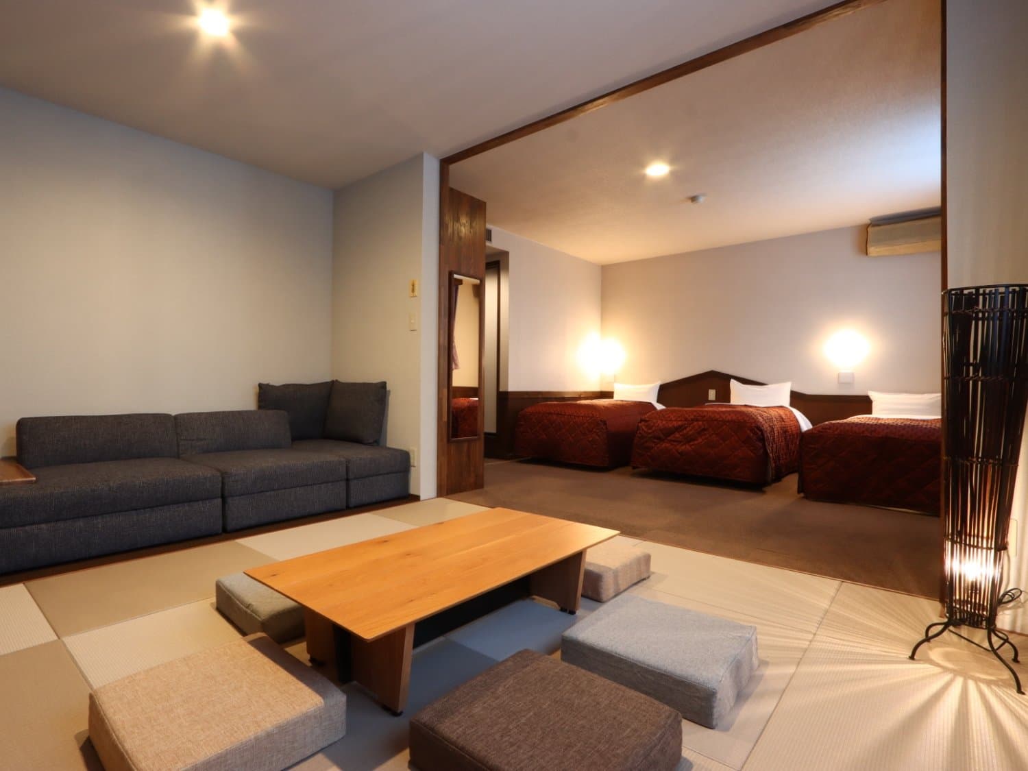 Spacious Japanese-Western guest room with twin beds, sofa and a tatami sitting area at Hotel Cerulean Alpen