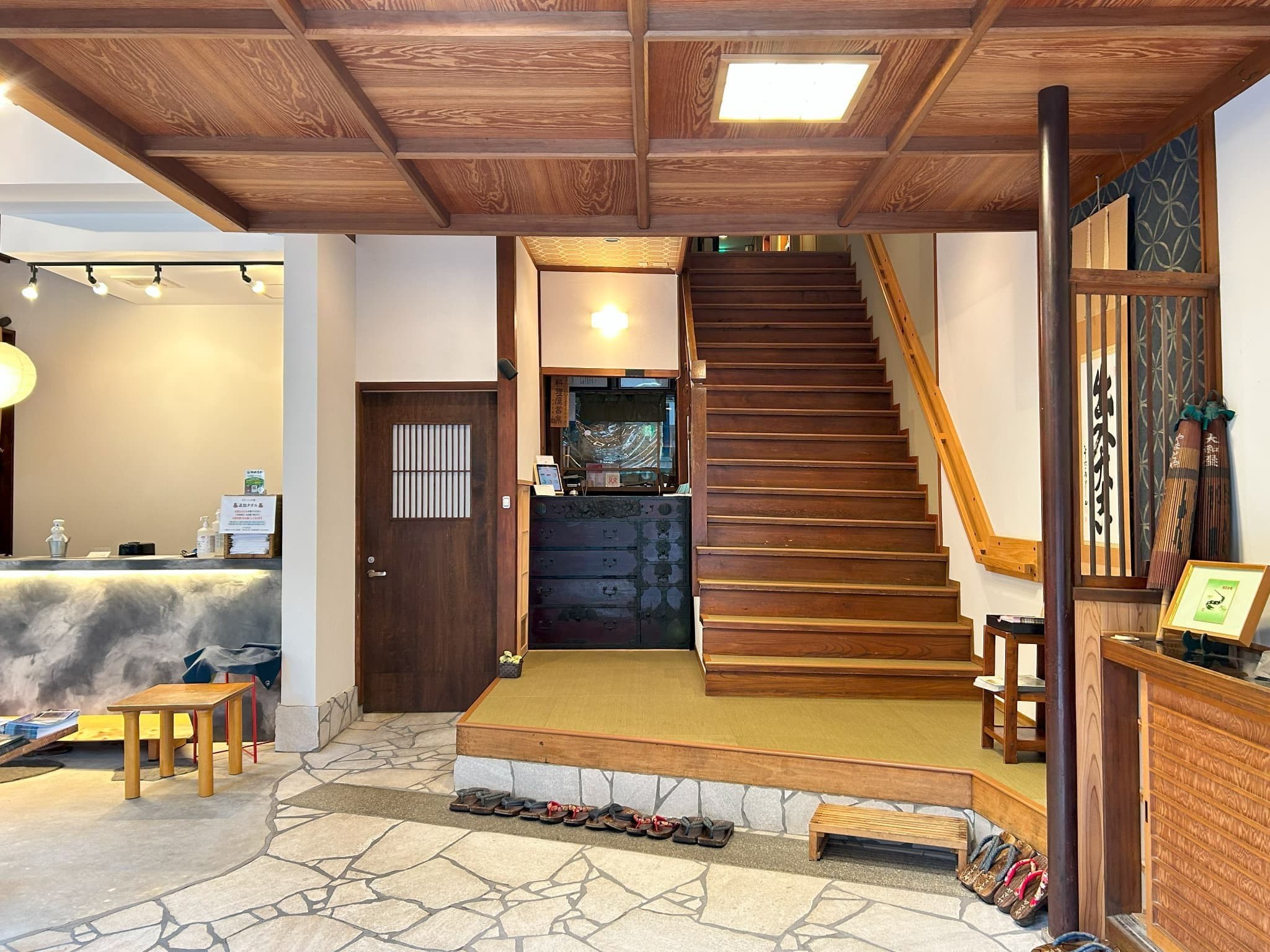 Yamatoya Ryokan Kinosaki Onsen lounge area with armchairs beside a large garden-view window