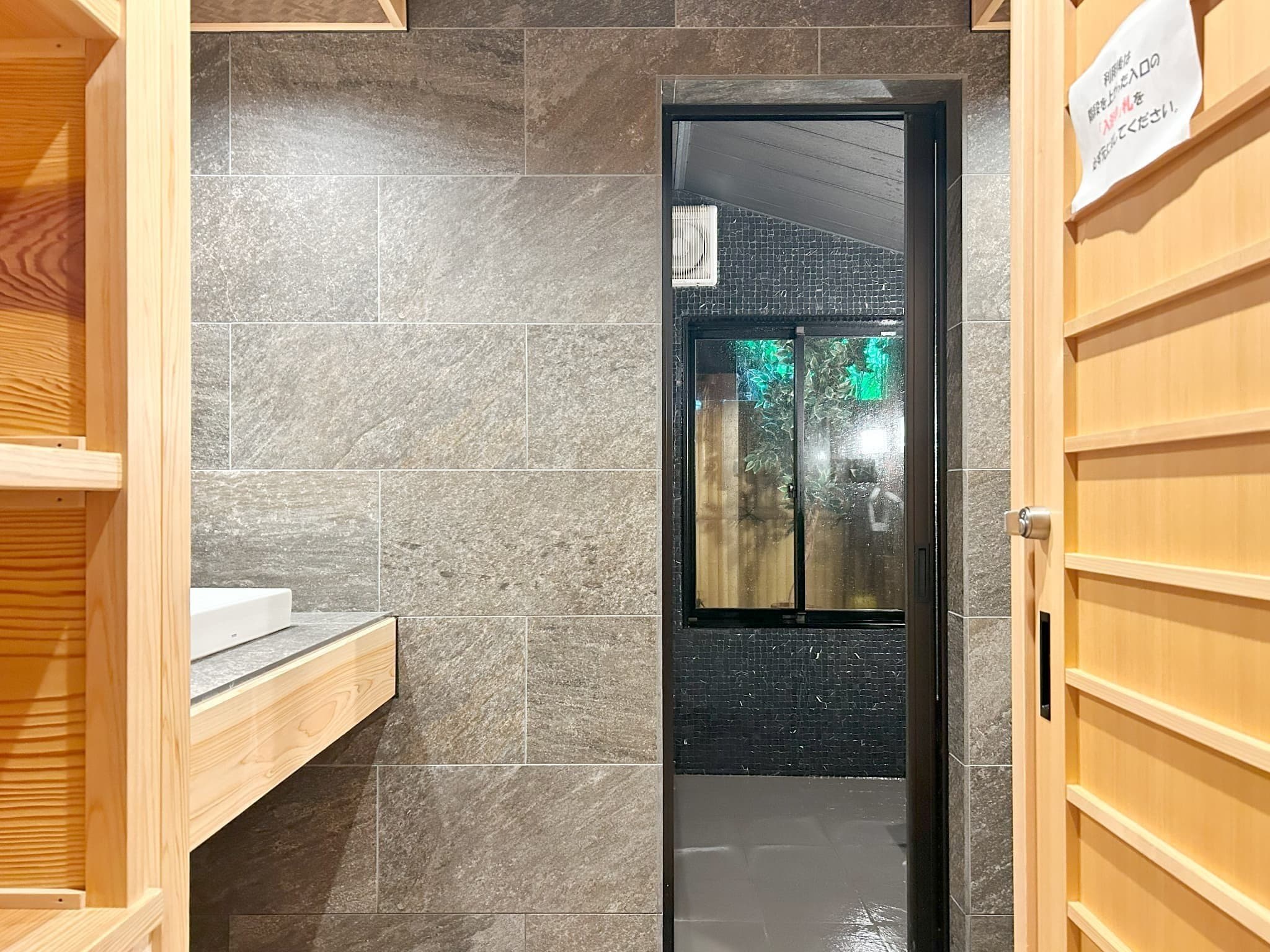 Yamatoya Ryokan Kinosaki Onsen indoor stone bath with window letting in natural light