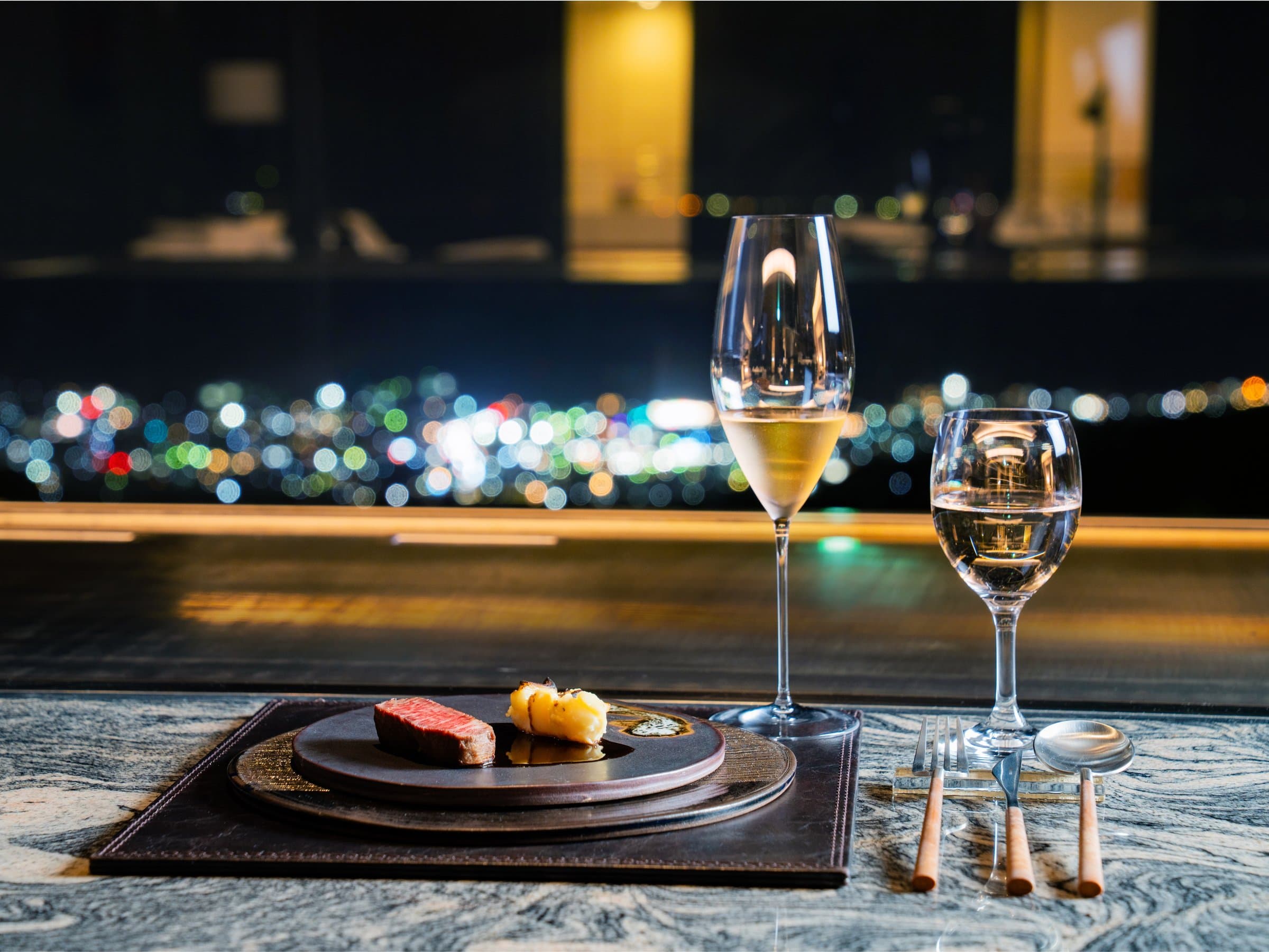 Seared wagyu course paired with sparkling wine before a glittering night view at Bettei Amafuru Oka, Ibusuki