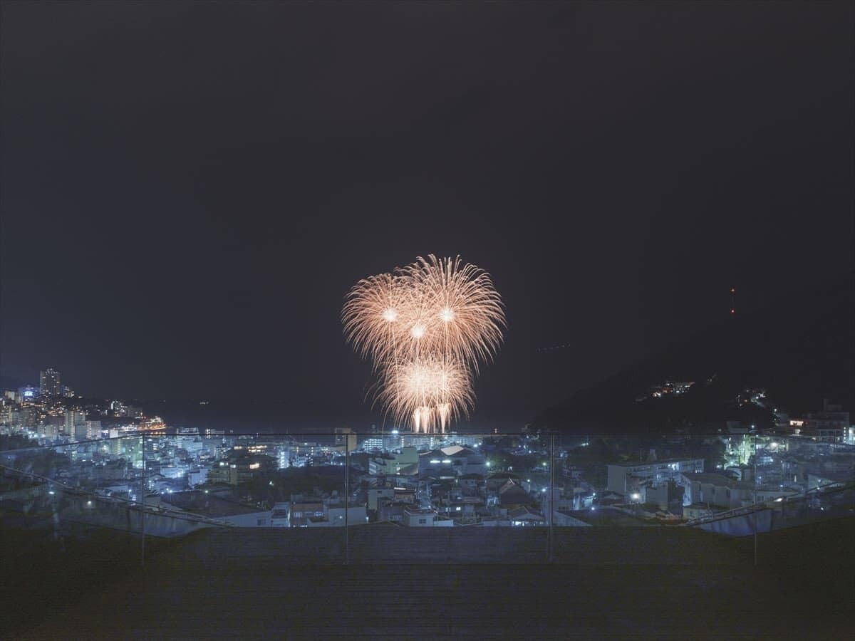 Fireworks over Atami bay and town seen from the rooftop terrace of SOKI ATAMI at night