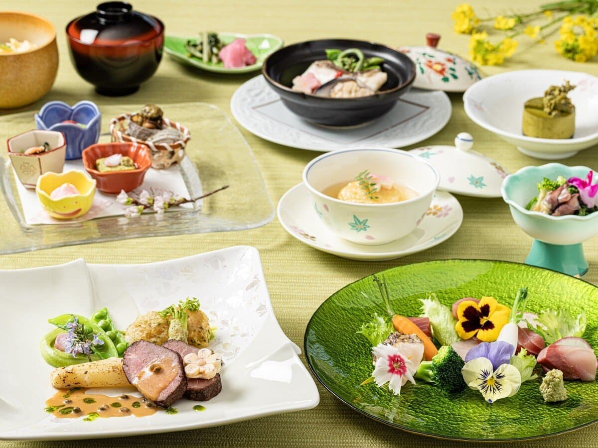Seasonal kaiseki dinner of multiple courses on patterned plates and lacquerware at Sanshi Suimei, Izu