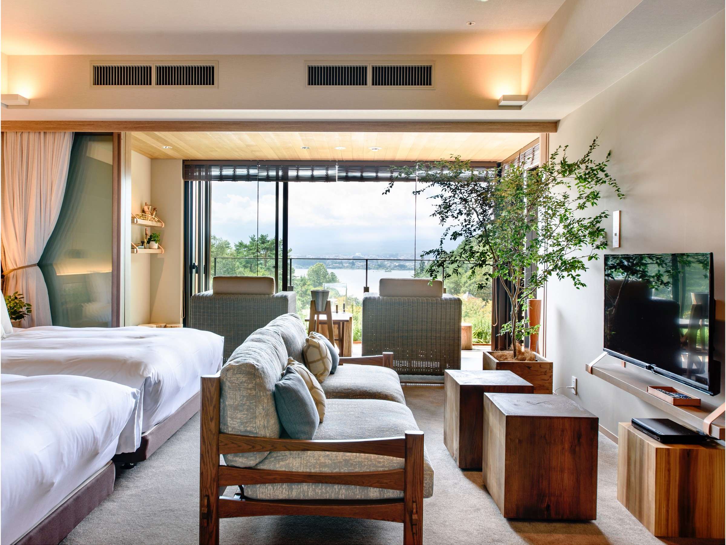 Twin-bed Fufu Kawaguchiko guest room with a sitting area overlooking Lake Kawaguchiko
