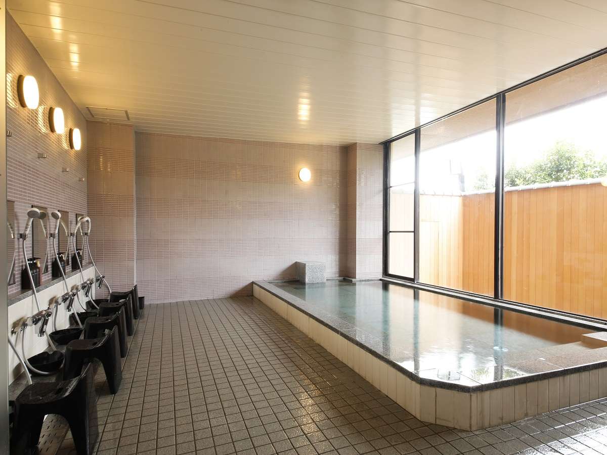 Warmly lit lobby lounge with armchairs and timber detailing at Spa Terrace Shisui