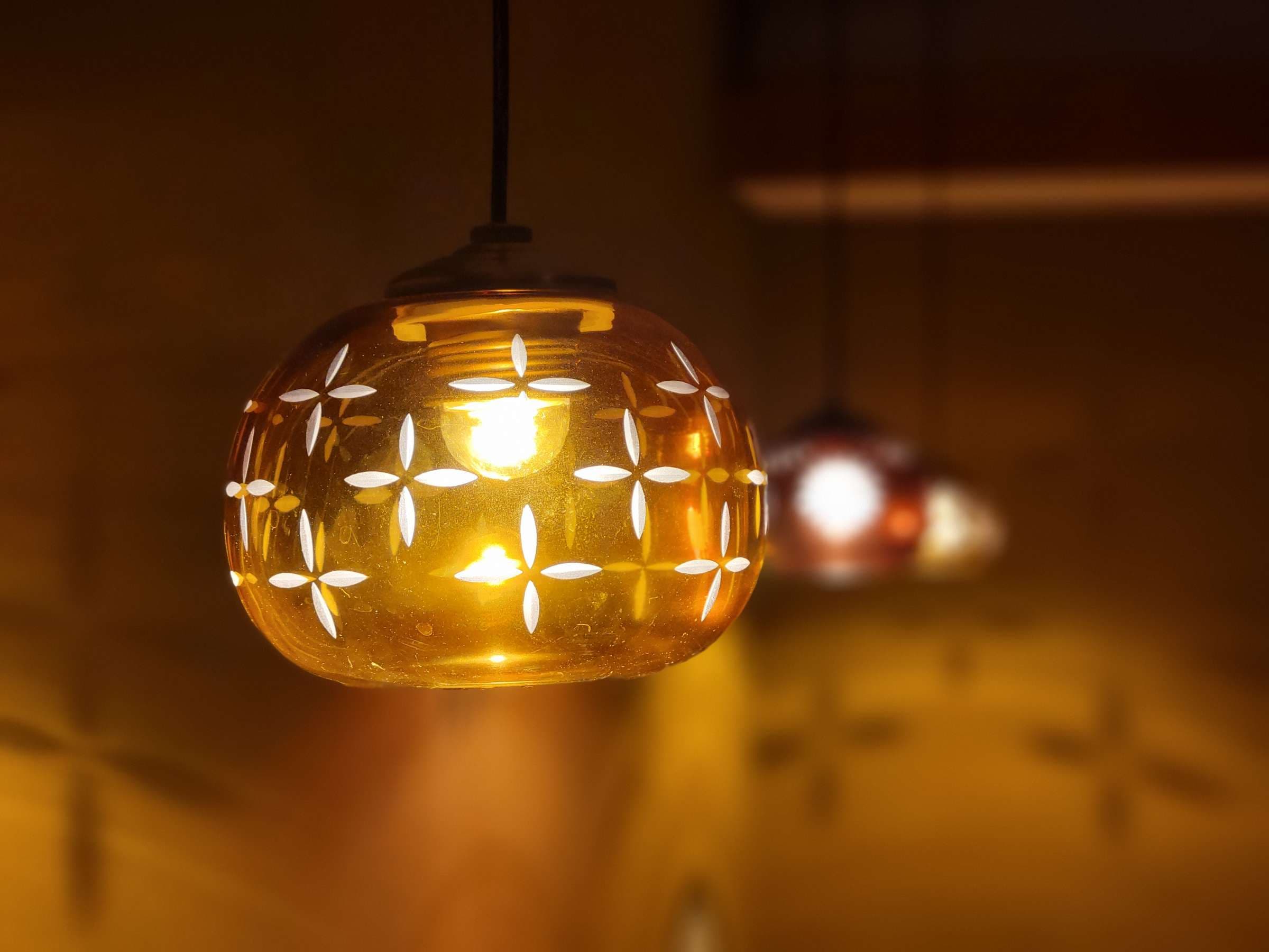 Amber cut-glass pendant lamp with floral patterns casting warm light, Tsukimotoya, Kinosaki Onsen