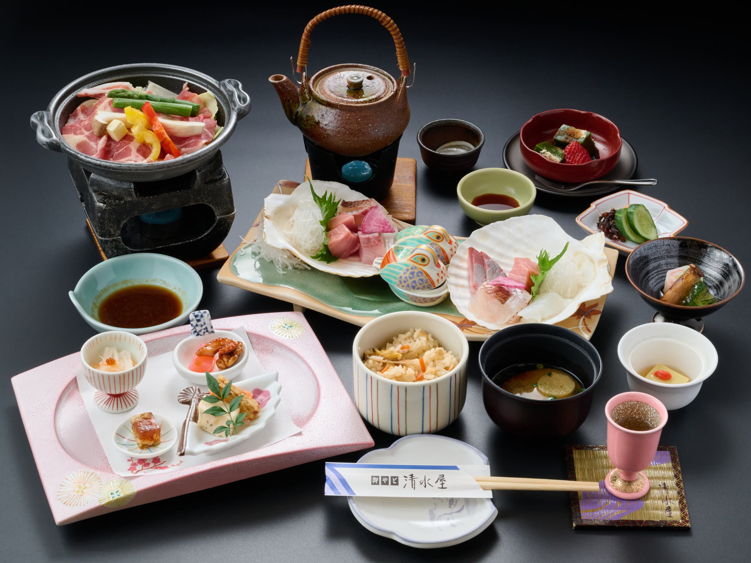 Multi-course Japanese kaiseki dinner spread with sashimi, hotpot and seasonal dishes at Oyado Kiyomizuya